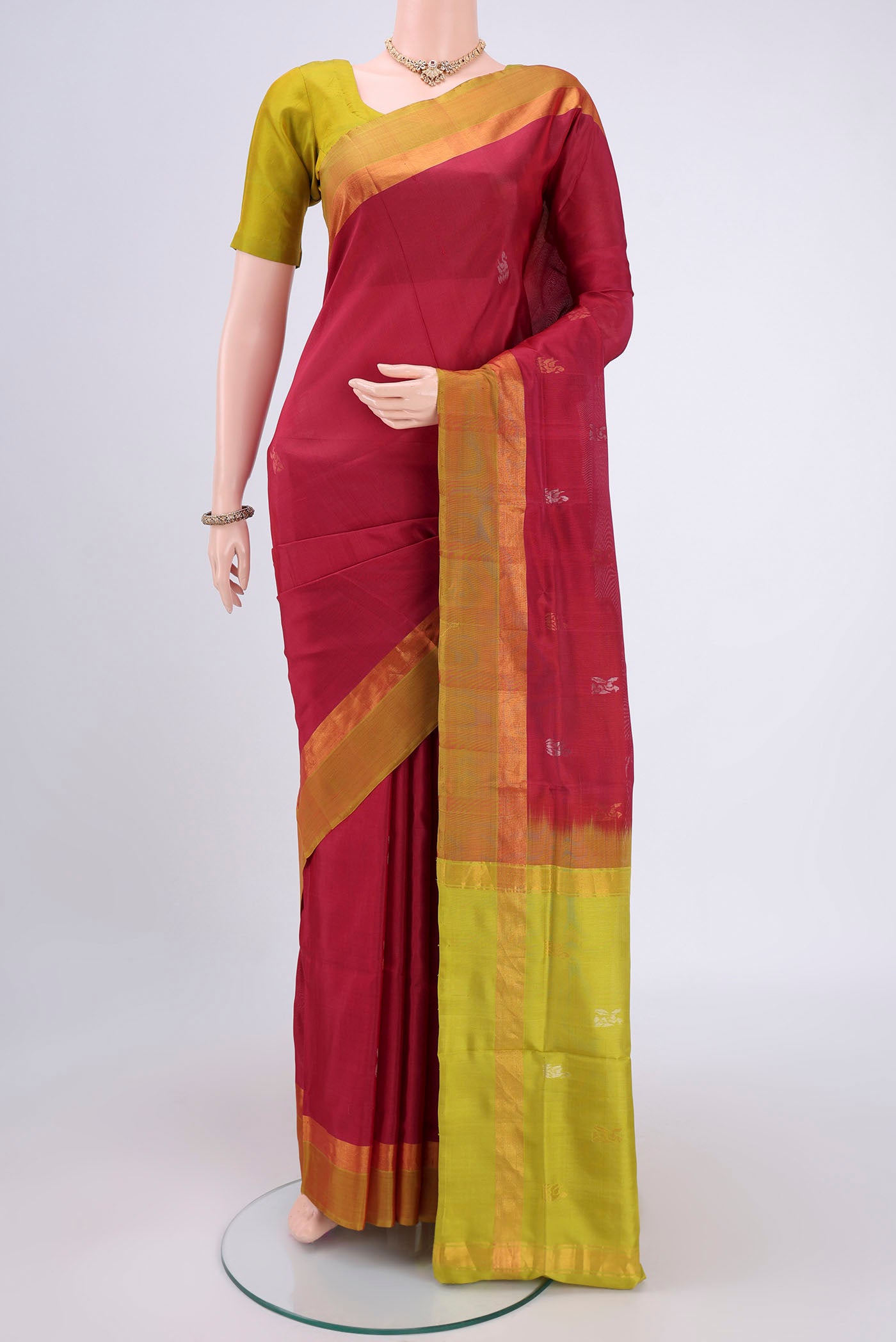 Rani Pink Uppada Silk Saree with Zari Butta on the body and Zari Border.  displayed on a mannequin