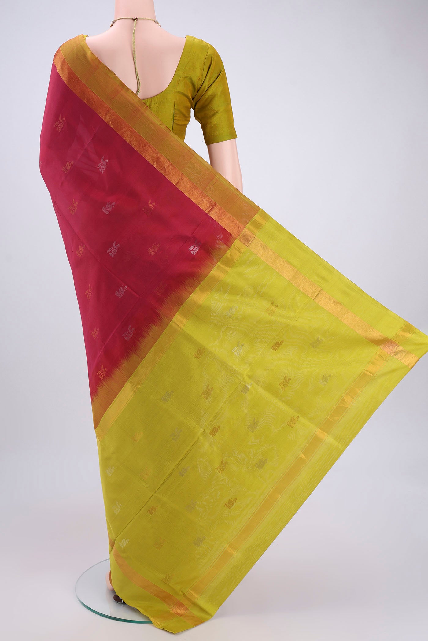 Flat view of Rani Pink Uppada Silk Saree with Zari Butta on the body and Zari Border. 