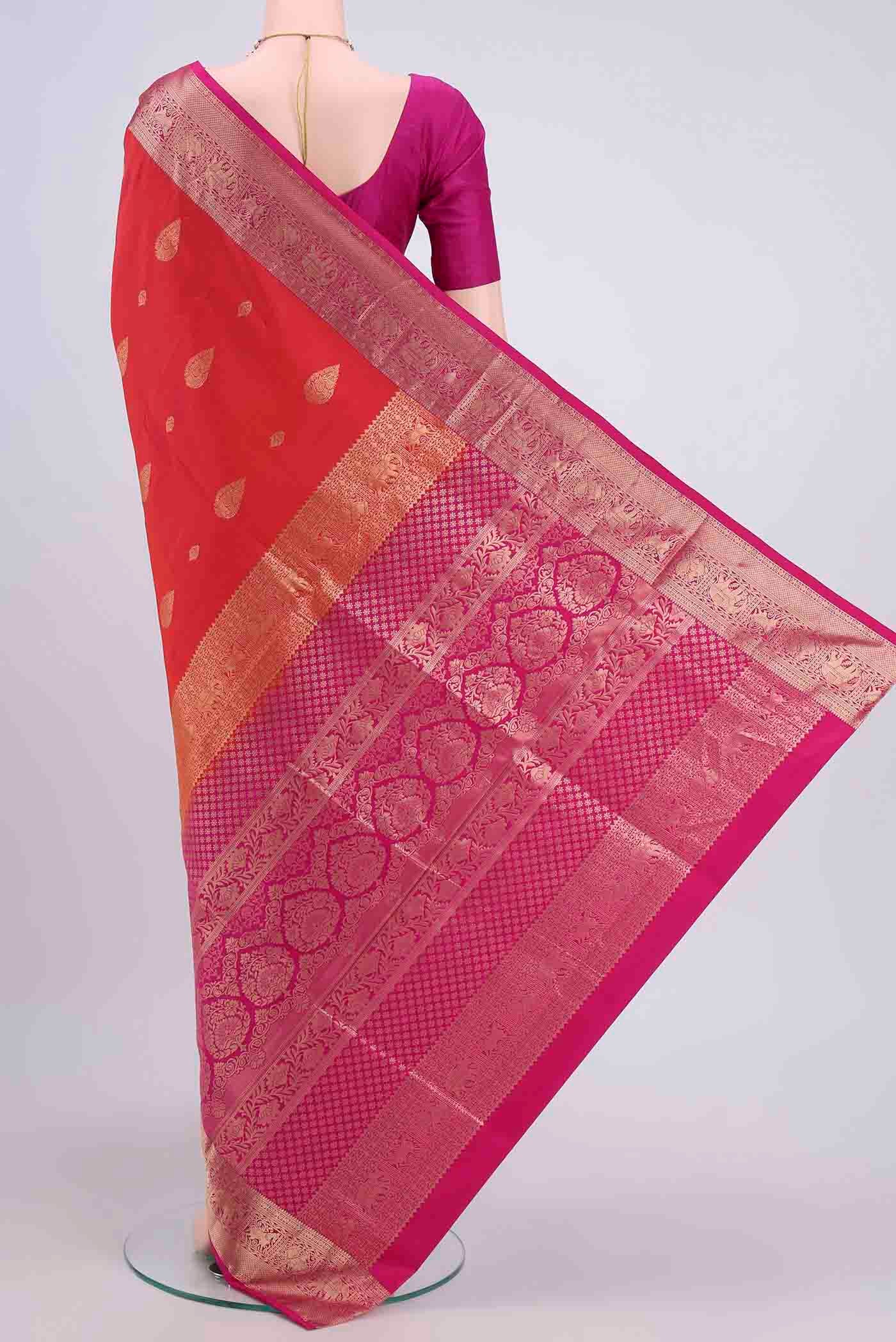 Flat view of Orange with Pink Color Soft Silk Saree with Zari Butta on the body and Zari Border