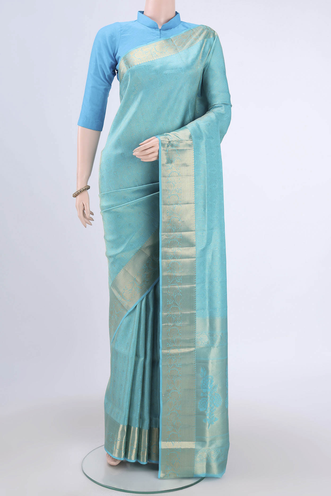 Turquoise Soft Silk Saree with Zari Brocade on the body and Zari Border.  displayed on a mannequin