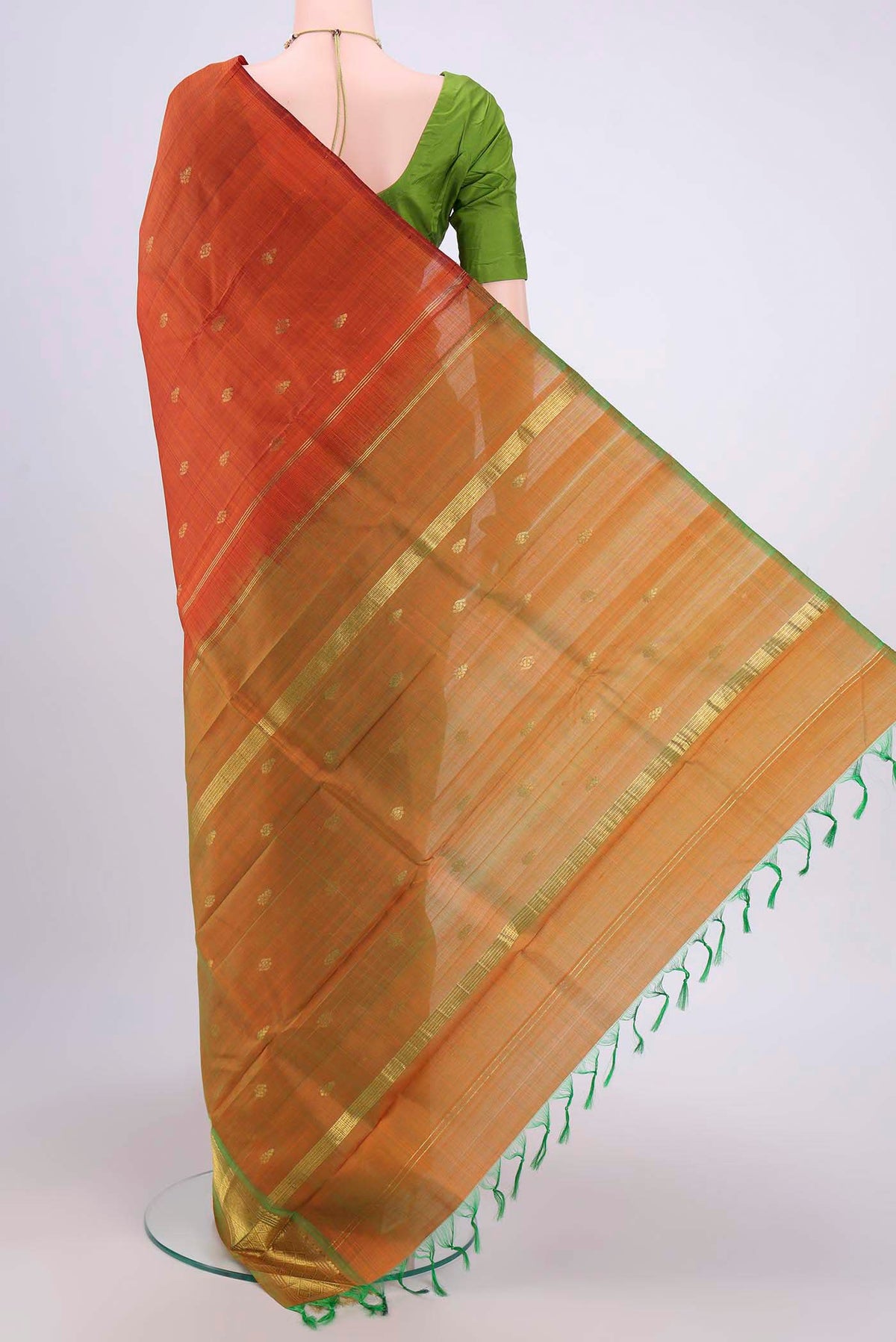 Flat view of Rust Kanjivaram Silk Saree with Zari Butta on the body and One Side Border. 
