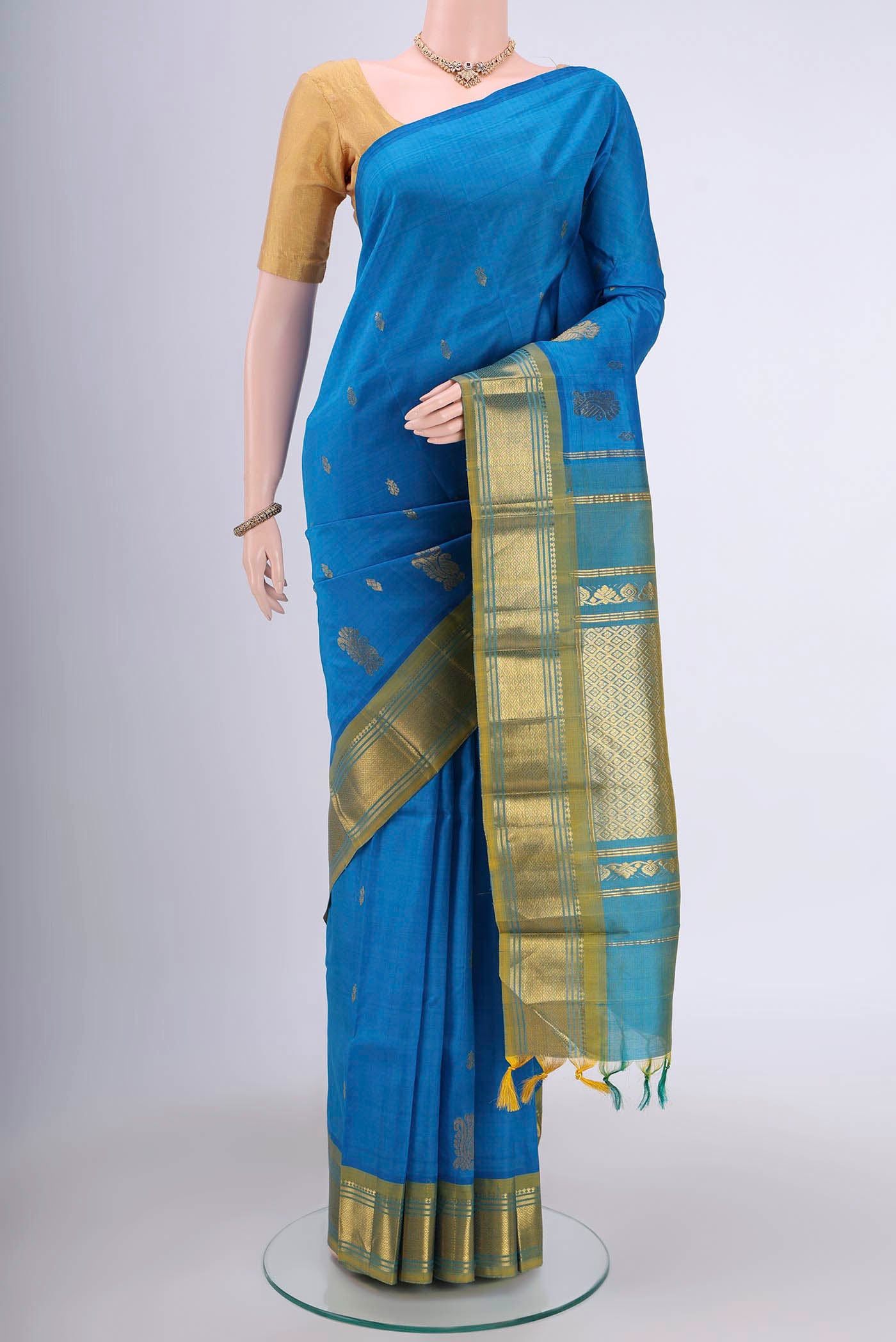 Blue Kanjivaram Silk Saree with Zari Butta on the body and One Side Border.  displayed on a mannequin