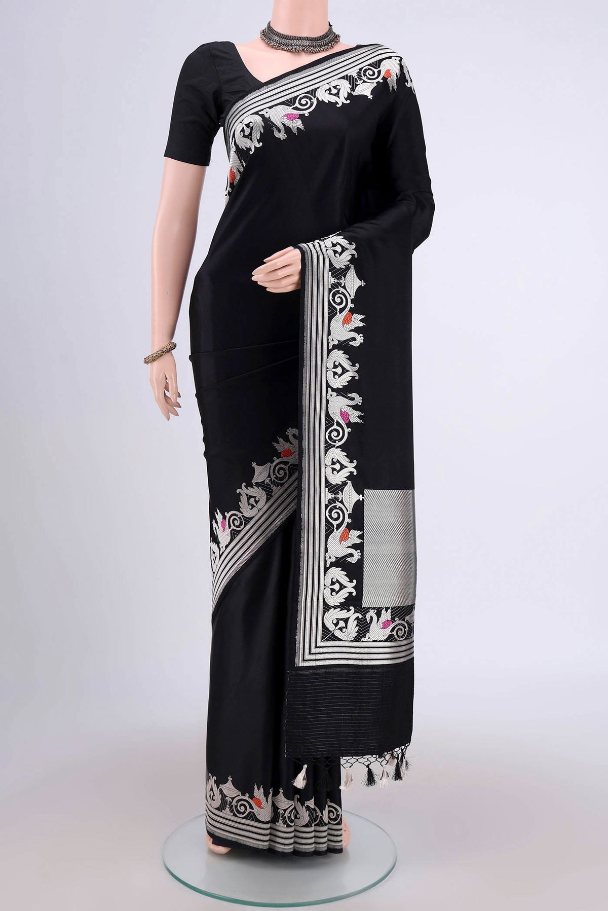 Black Assam Silk Saree with Zari Butta on the body and Zari Border.  displayed on a mannequin