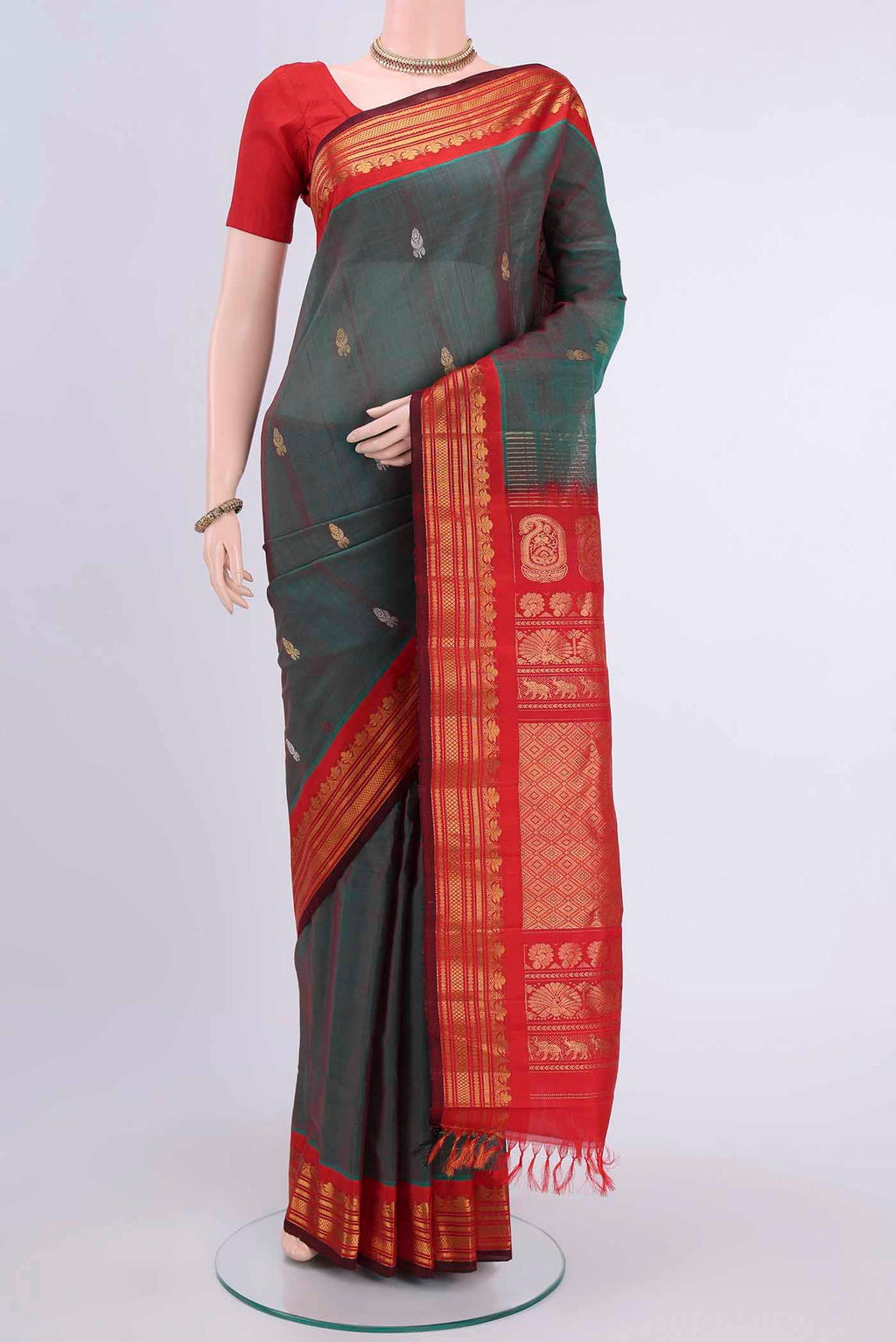 Green with Red Color Gadwal Silk Cotton Saree with Zari Butta on the body and Zari Border displayed on a mannequin