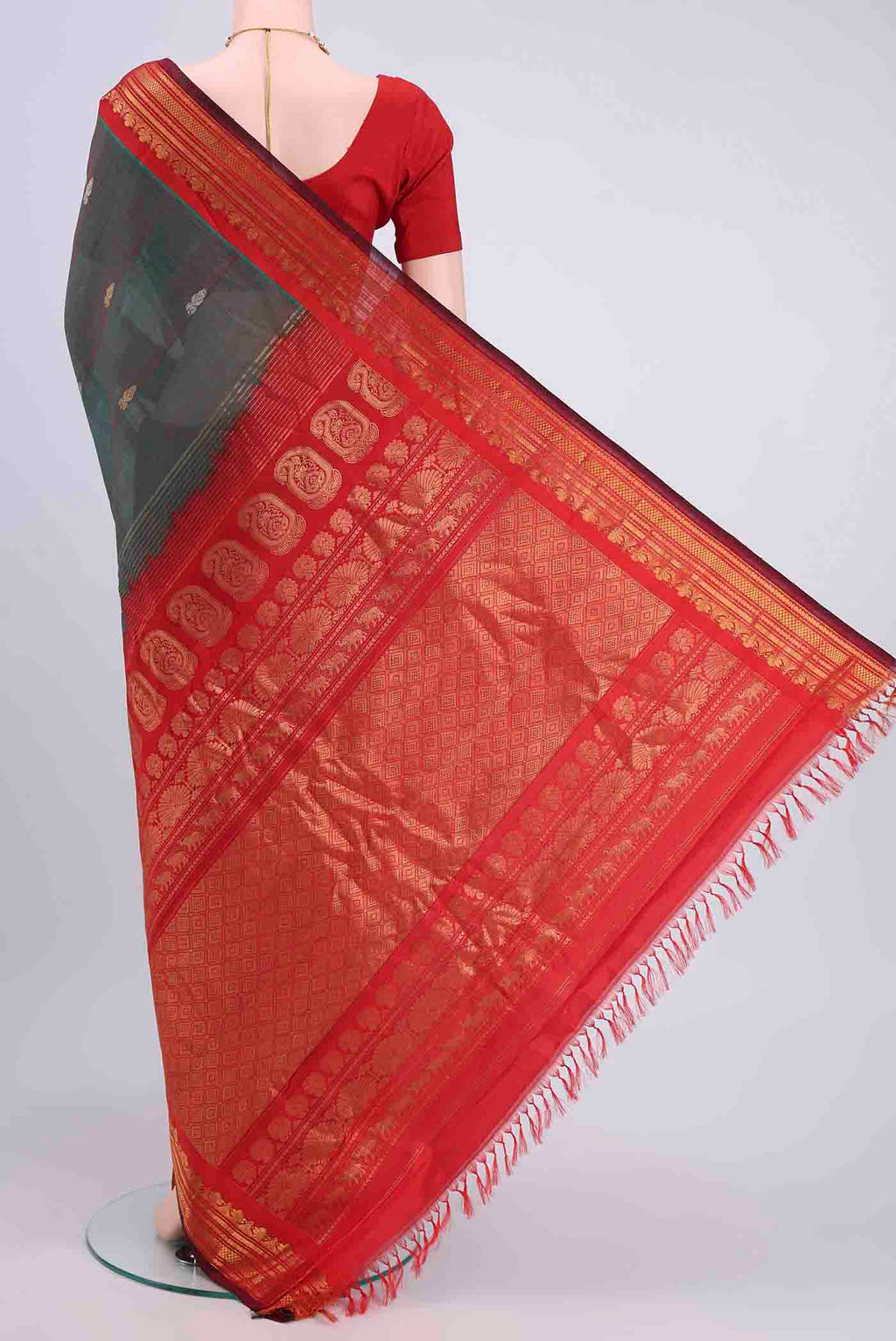 Flat view of Green with Red Color Gadwal Silk Cotton Saree with Zari Butta on the body and Zari Border