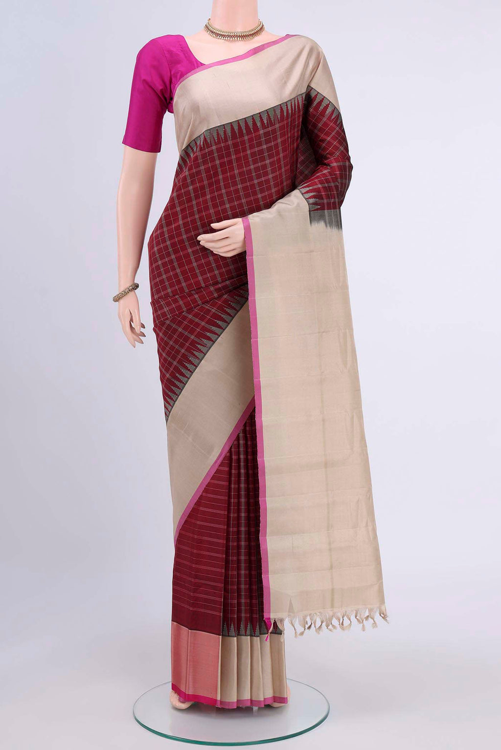 Maroon Gadwal Silk Saree with Checked design on the body and Plain Border displayed on a mannequin