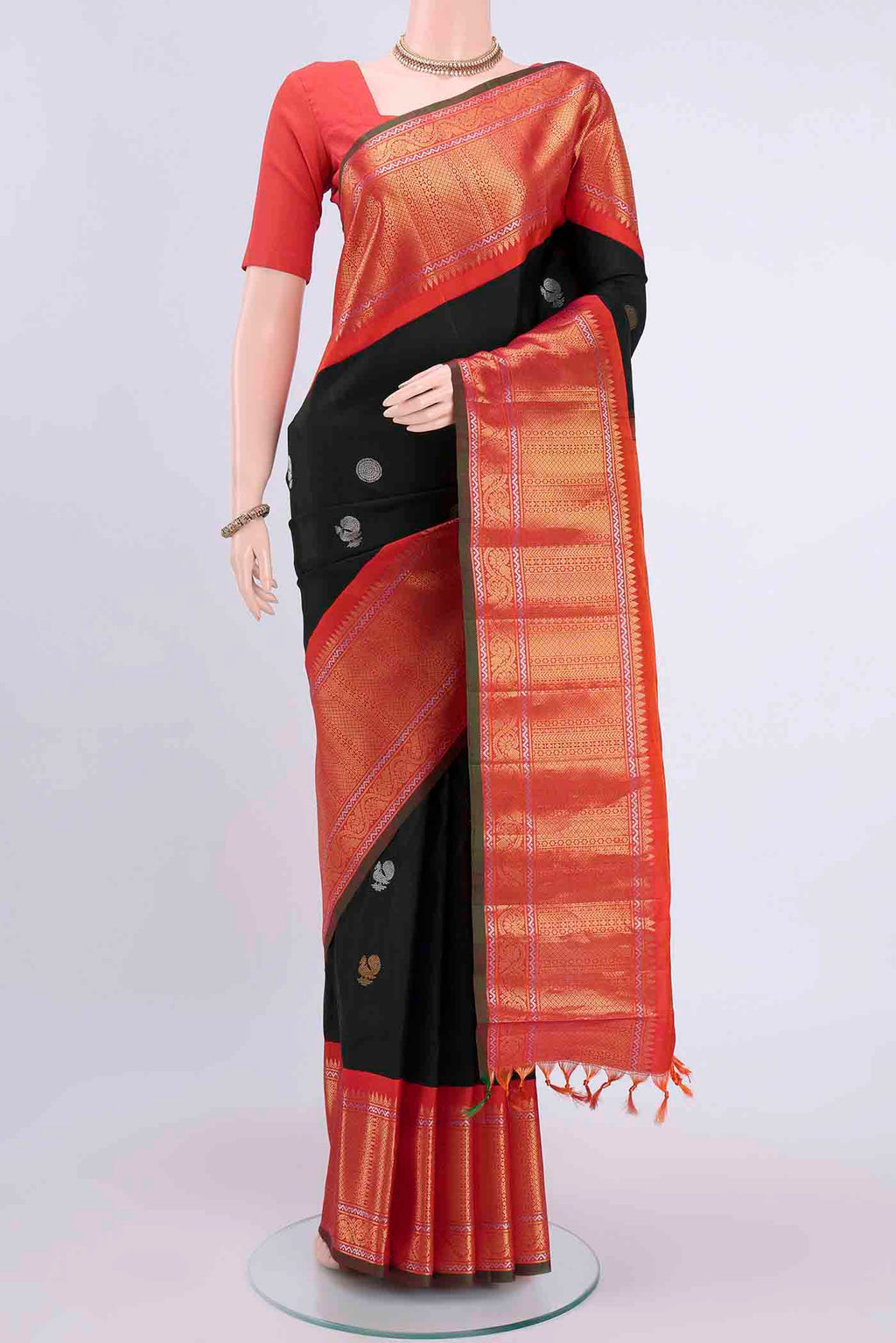 Black Gadwal Silk Saree with Zari Butta on the body and Zari Border displayed on a mannequin