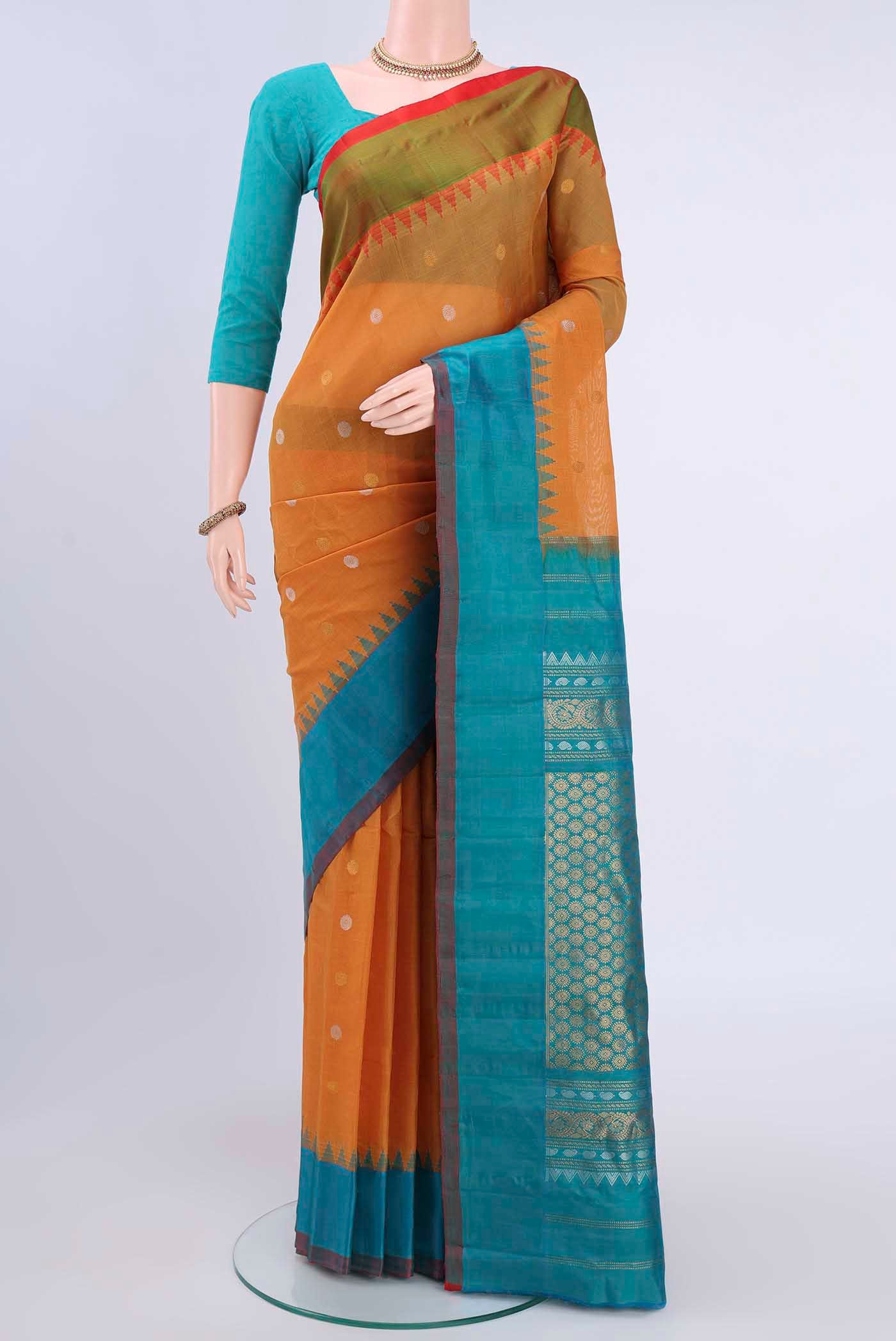 Mustard Gadwal Silk Saree with Zari Butta on the body and Plain Border displayed on a mannequin