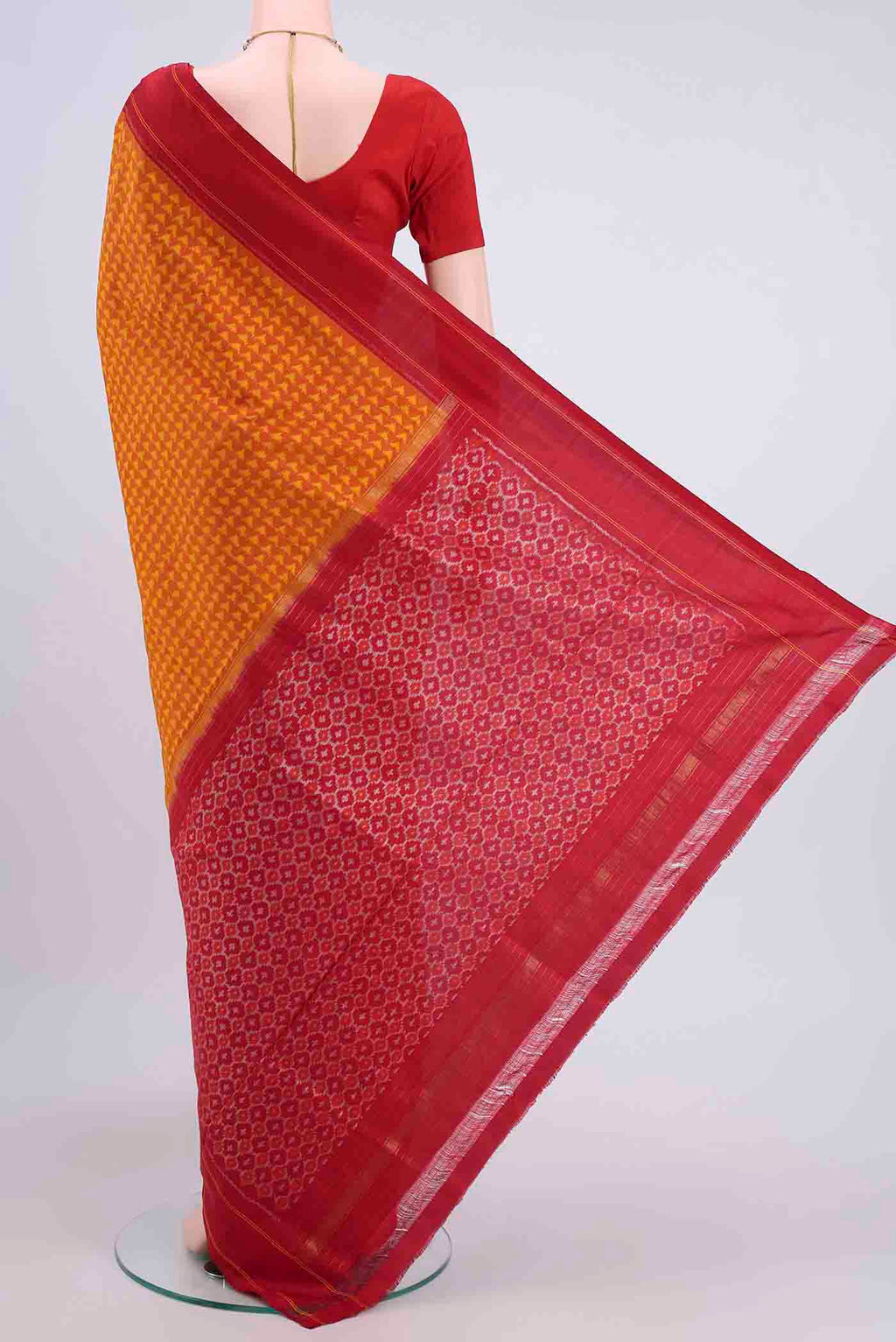 Flat view of Orange Pochampally Silk Saree with Pure Ikat on the body and Plain Border