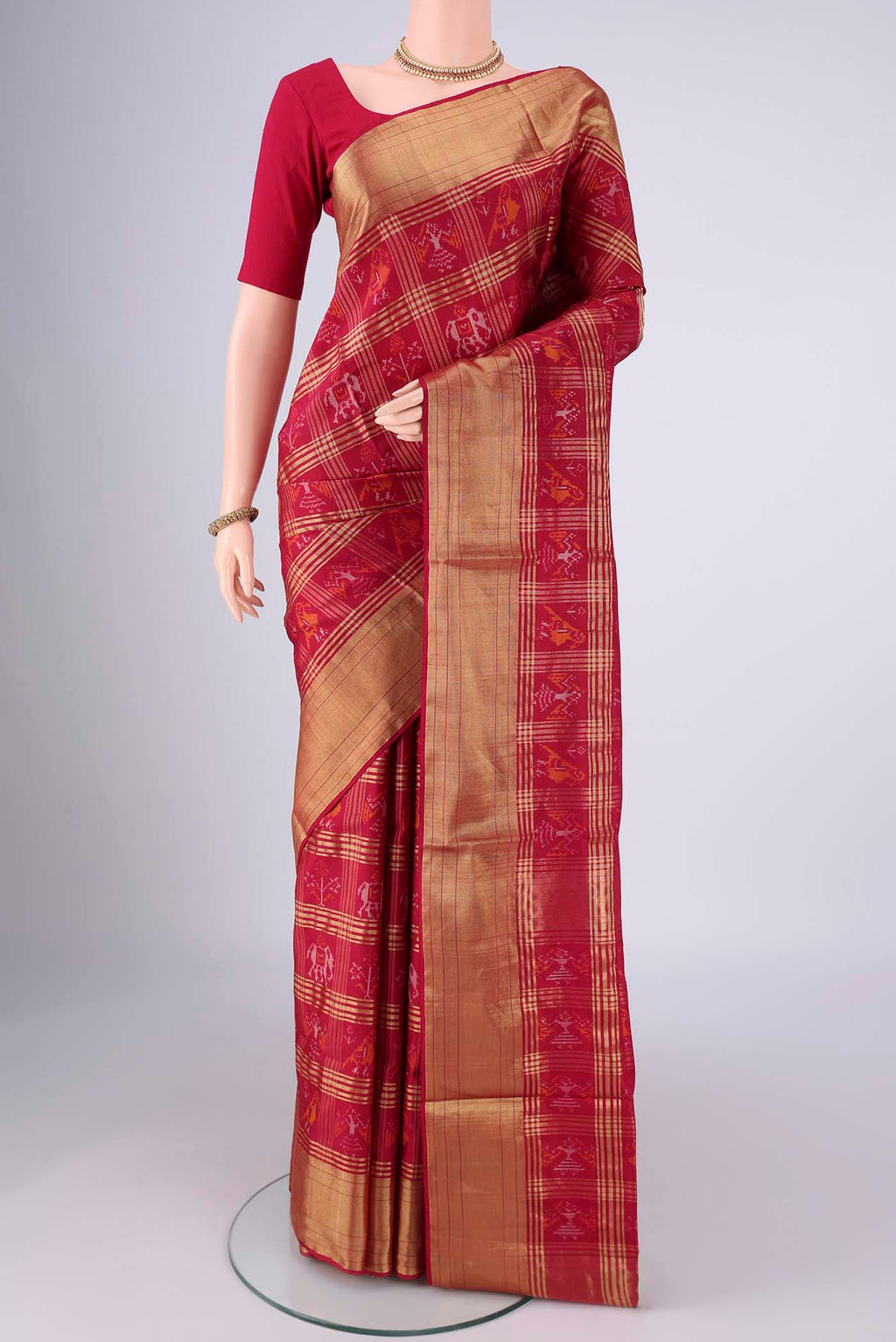 Maroon Pochampally Silk Saree with Pure Ikat on the body and Zari Border.  displayed on a mannequin
