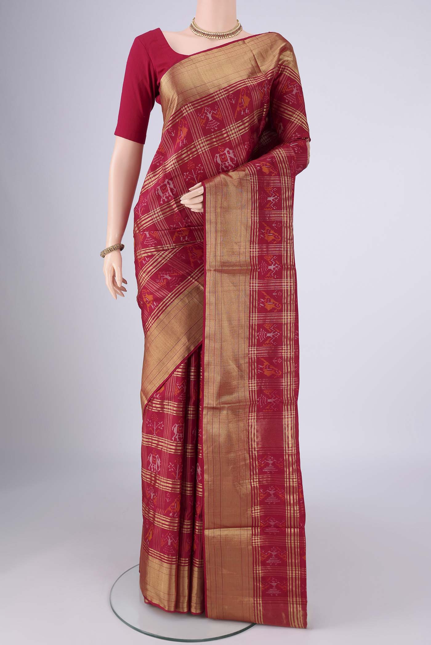 Maroon Pochampally Silk Saree with Pure Ikat on the body and Zari Border.  displayed on a mannequin