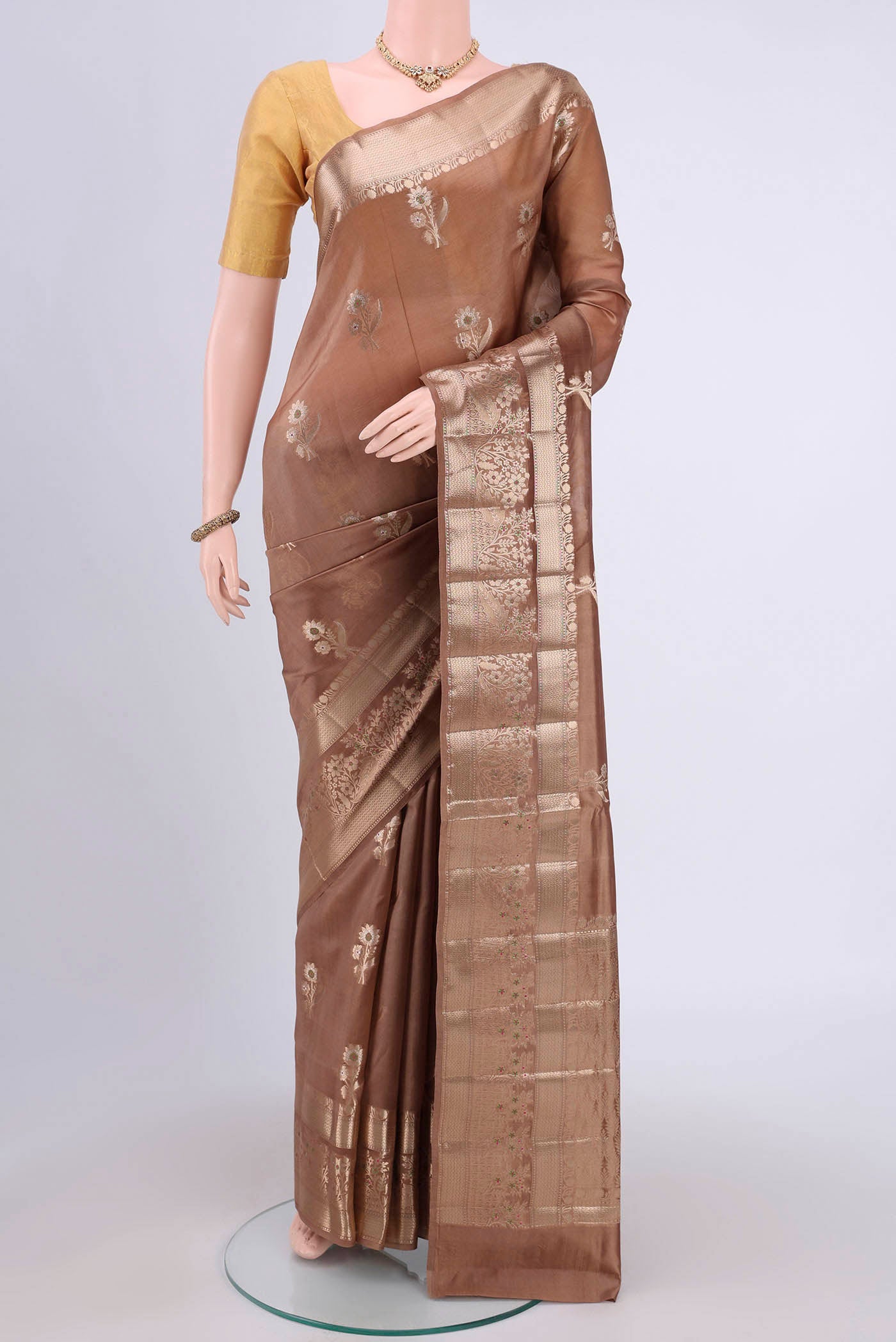 Dark Beige Banarasi Raw Silk Saree with Zari Butta on the body and Zari Border.  displayed on a mannequin