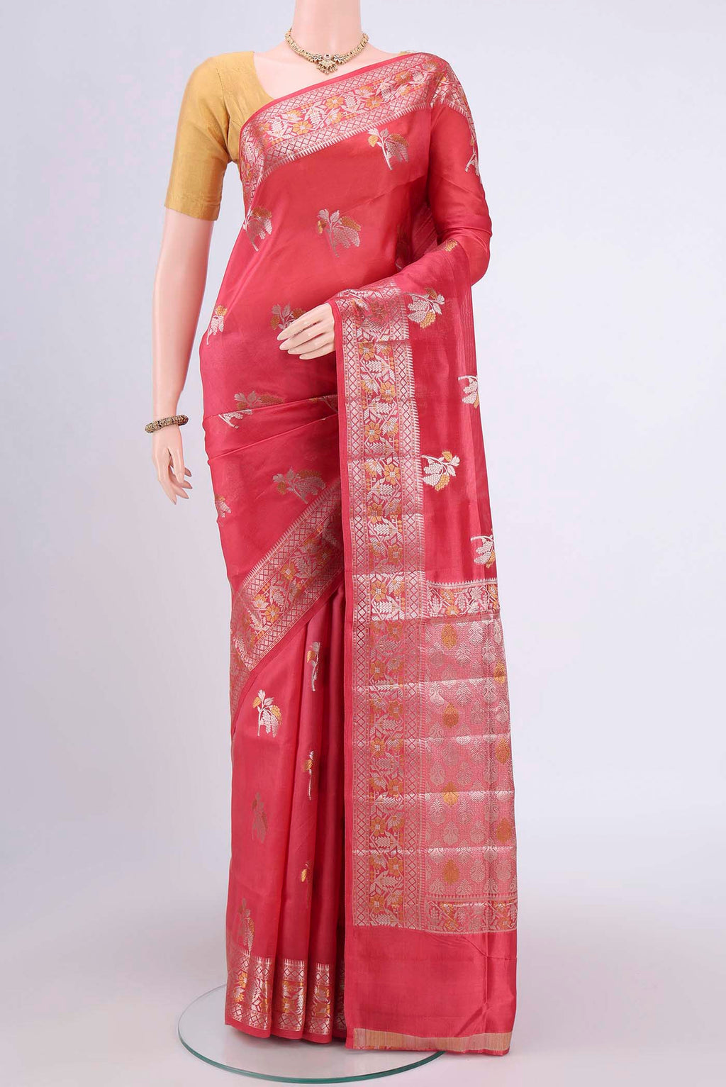 Peach Banarasi Raw Silk Saree with Zari Butta on the body and Zari Border.  displayed on a mannequin