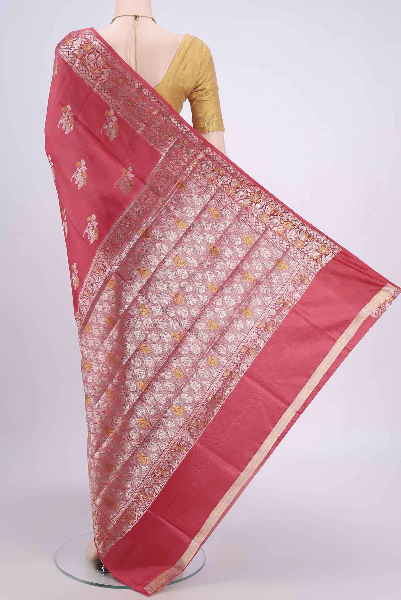 Flat view of Peach Banarasi Raw Silk Saree with Zari Butta on the body and Zari Border. 