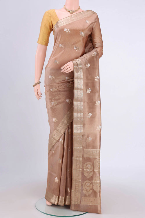 Beige Banarasi Raw Silk Saree with Zari Butta on the body and Zari Border.  displayed on a mannequin