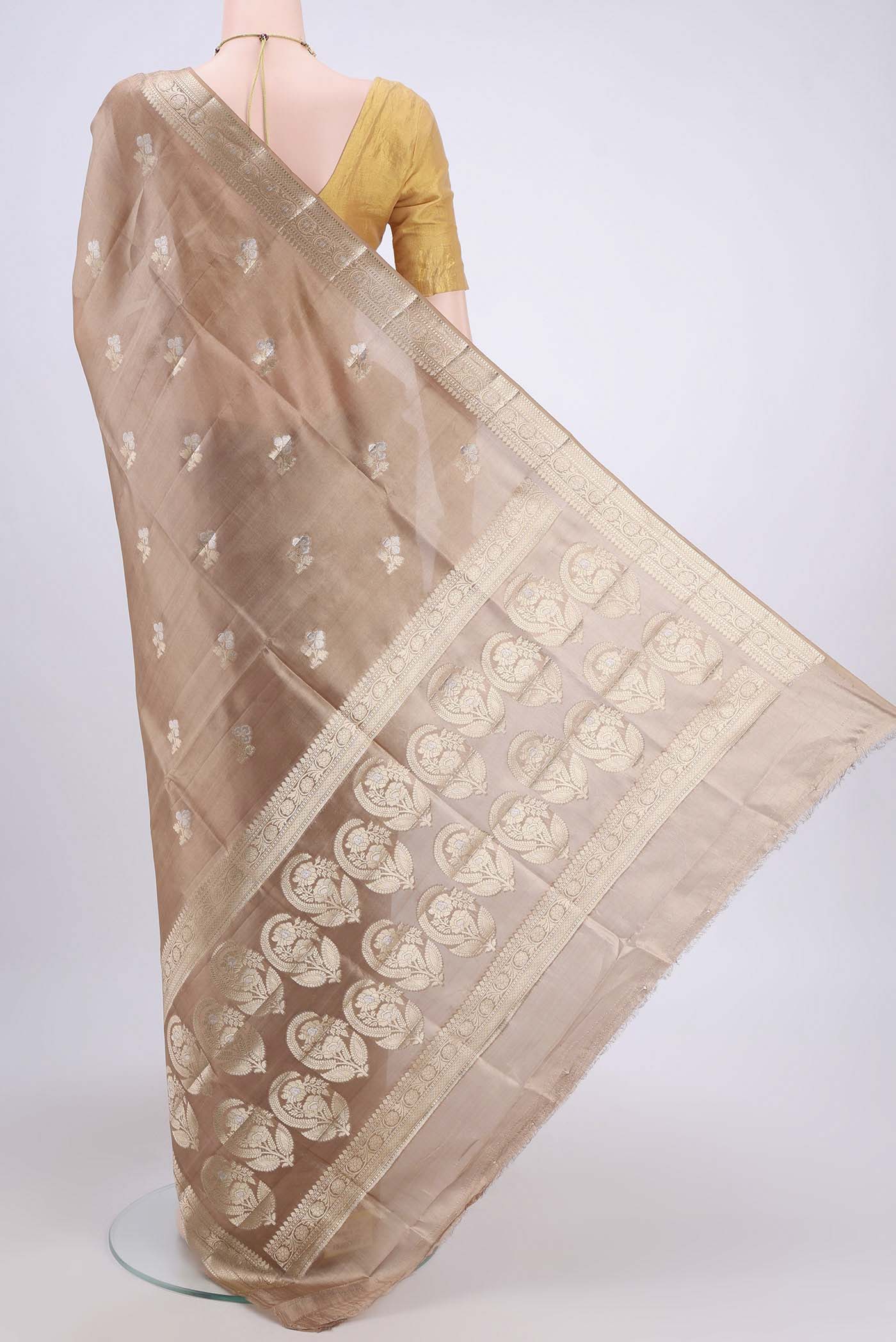 Flat view of Beige Banarasi Raw Silk Saree with Zari Butta on the body and Zari Border. 