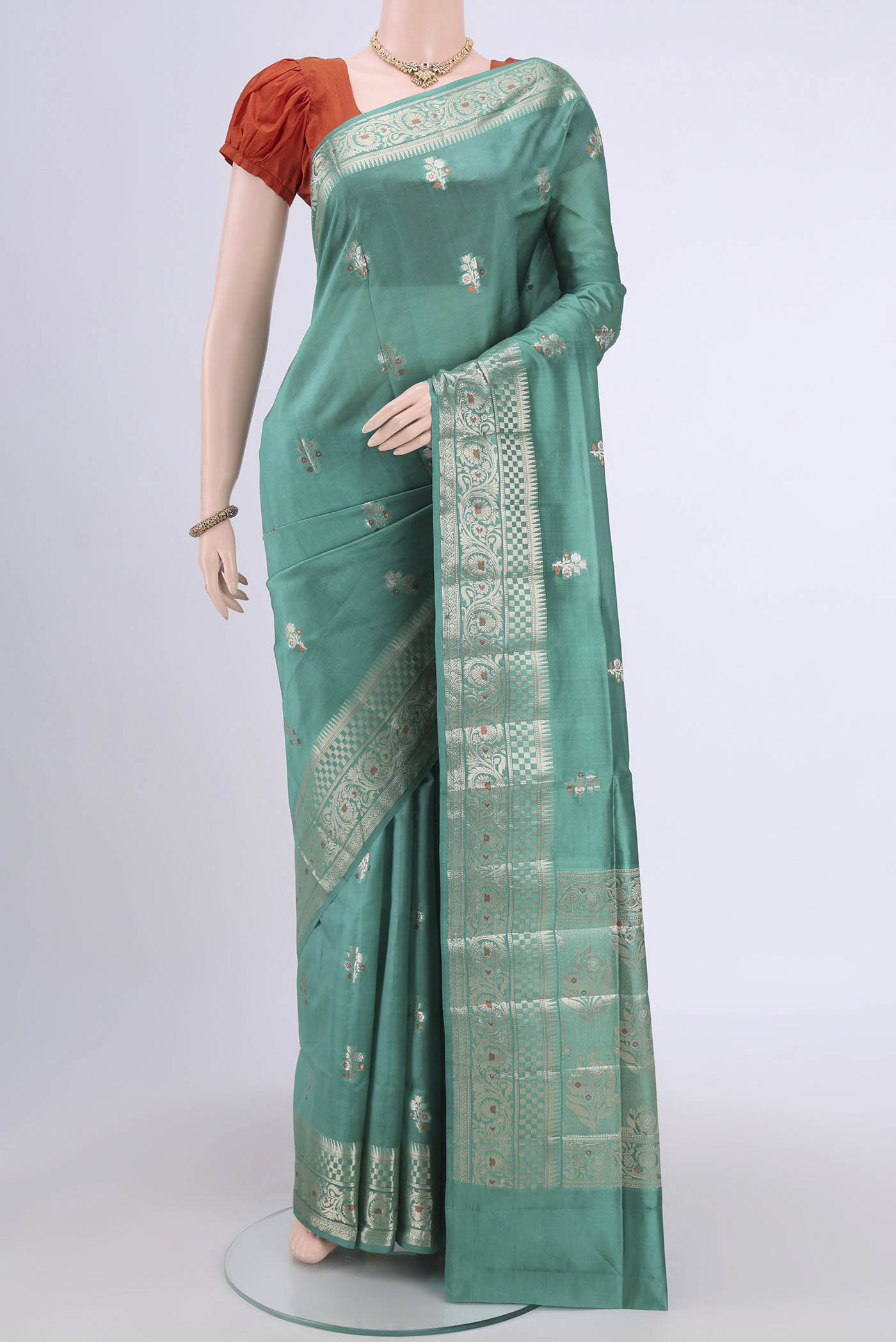 Sea Green Banarasi Raw Silk Saree with Zari Brocade on the body and Zari Border.  displayed on a mannequin