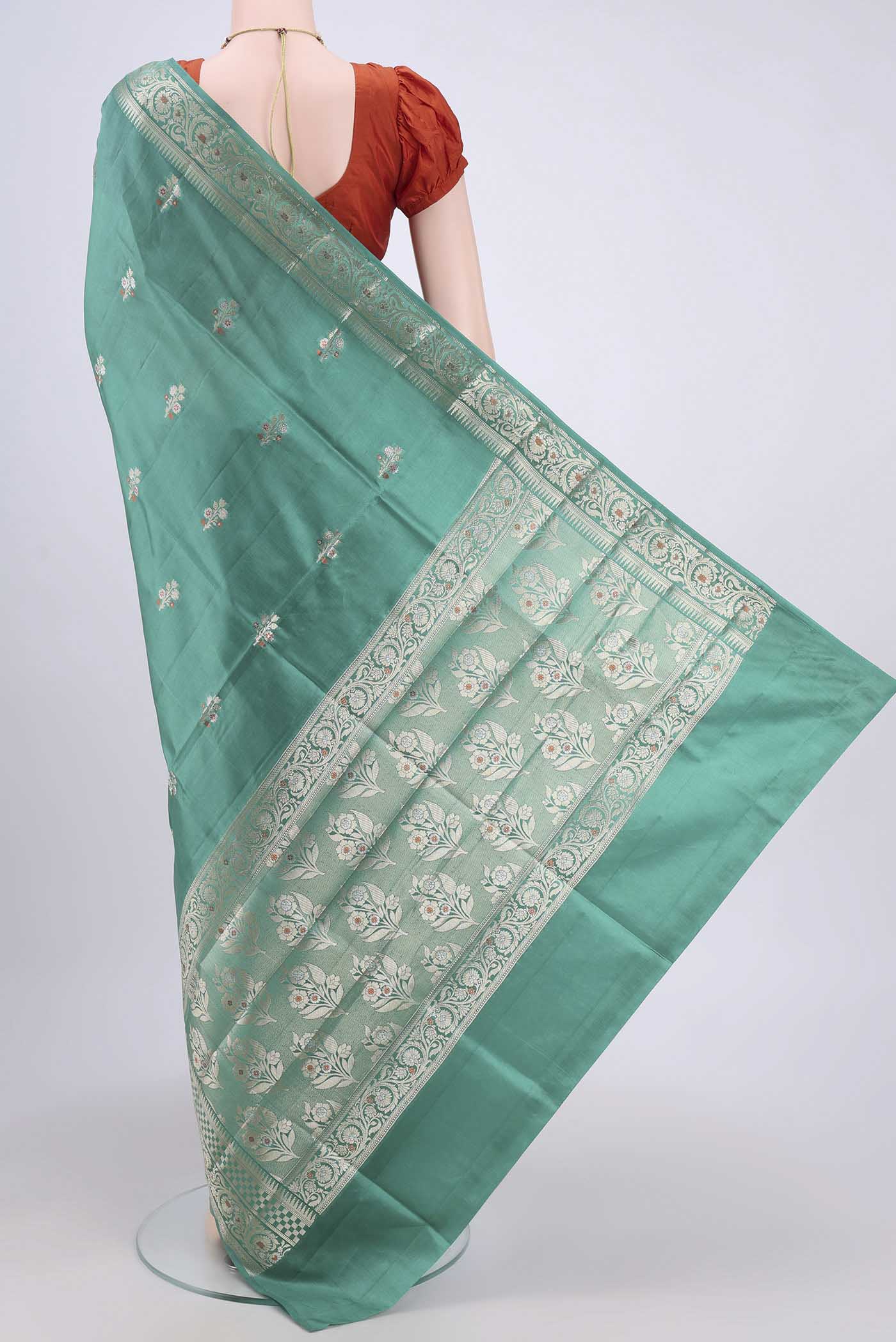 Flat view of Sea Green Banarasi Raw Silk Saree with Zari Brocade on the body and Zari Border. 