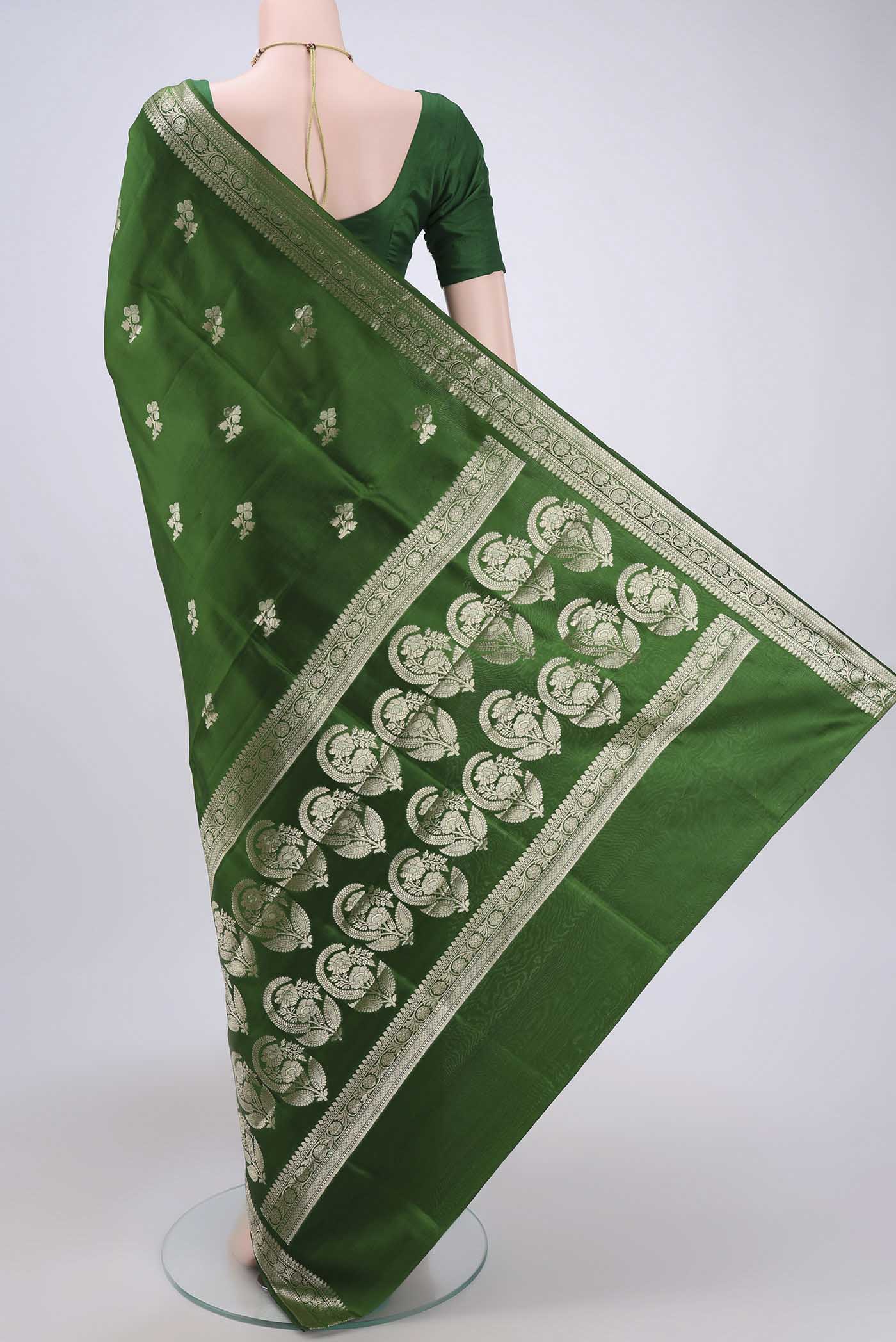 Flat view of Green Banarasi Raw Silk Saree with Zari Butta on the body and Zari Border. 