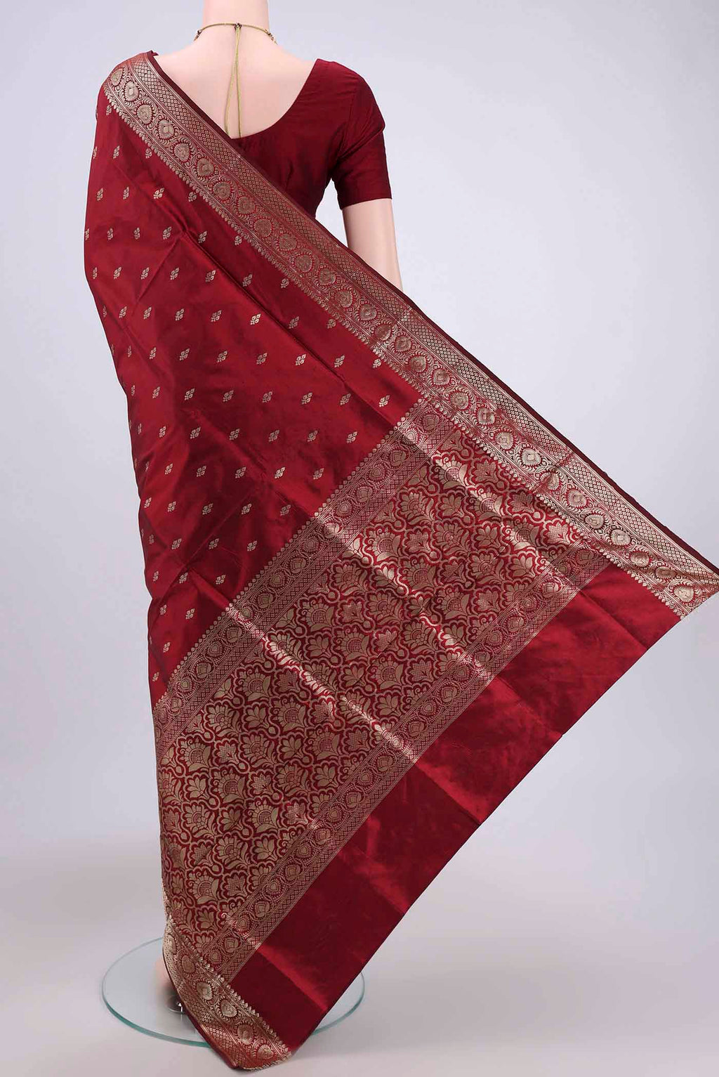 Flat view of Maroon Banarasi Katan Silk Saree with Zari Butta on the body and Zari Border. 