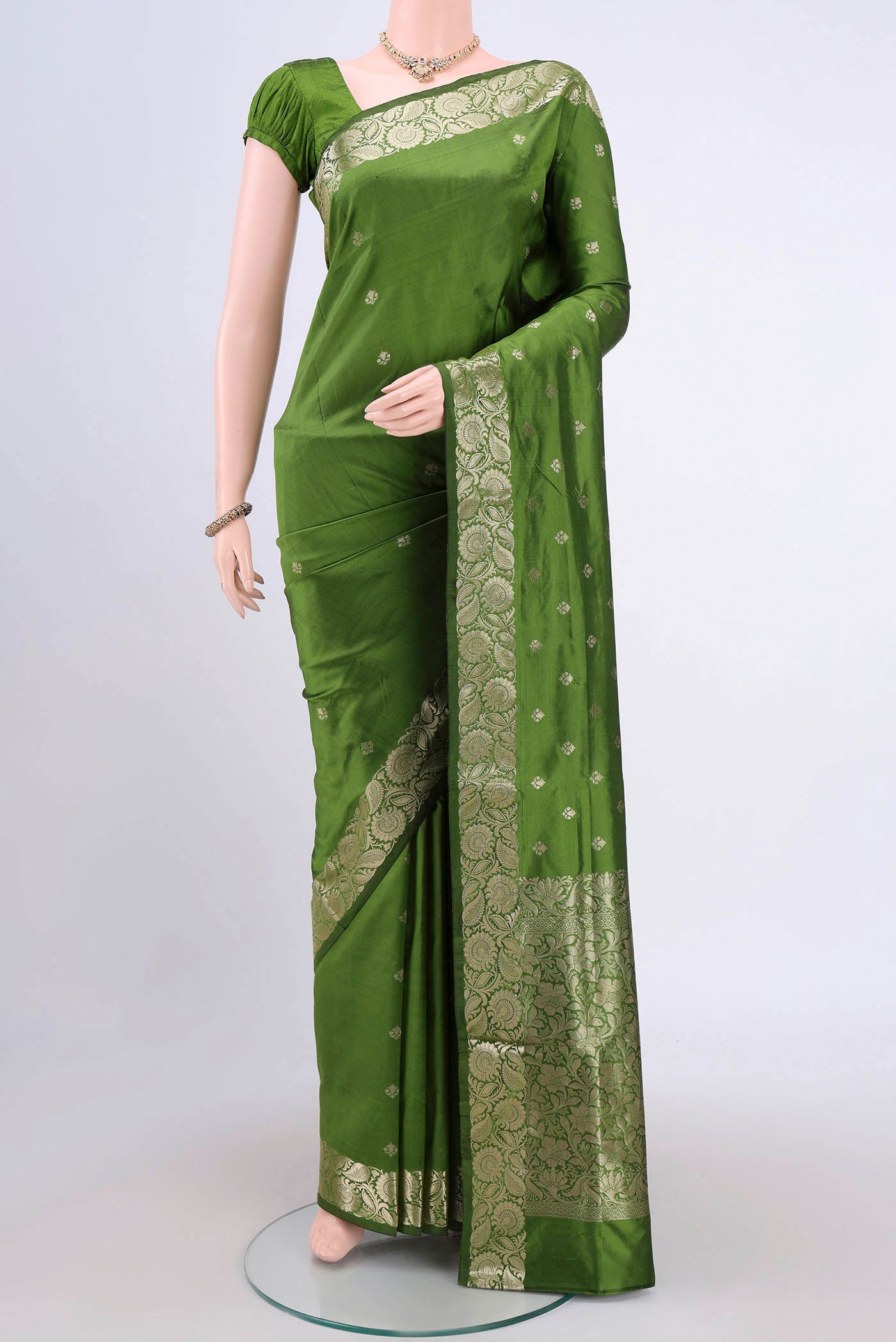 Light Green Banarasi Katan Silk Saree with Zari Butta on the body and Zari Border.  displayed on a mannequin