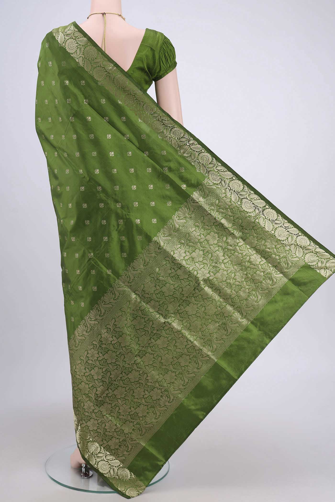 Flat view of Light Green Banarasi Katan Silk Saree with Zari Butta on the body and Zari Border. 