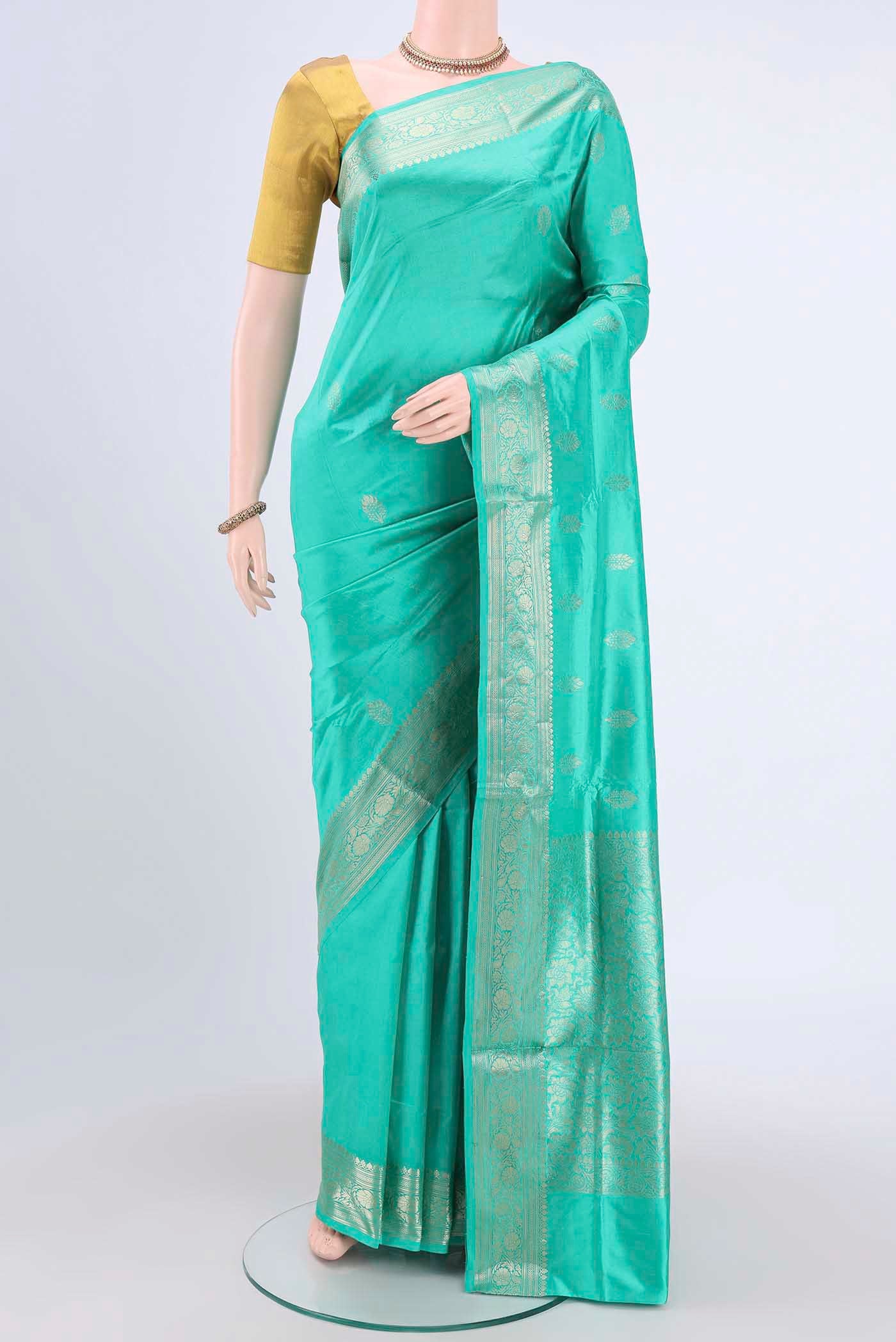 Turquoise Dual Tone Banarasi Katan Silk Saree with Thread Butta on the body and Thread Border.  displayed on a mannequin