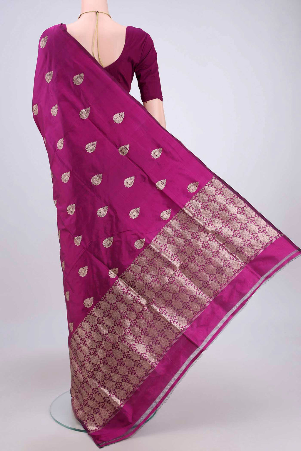 Flat view of Magenta Banarasi Katan Silk Saree with Zari Butta on the body and Without Border. 