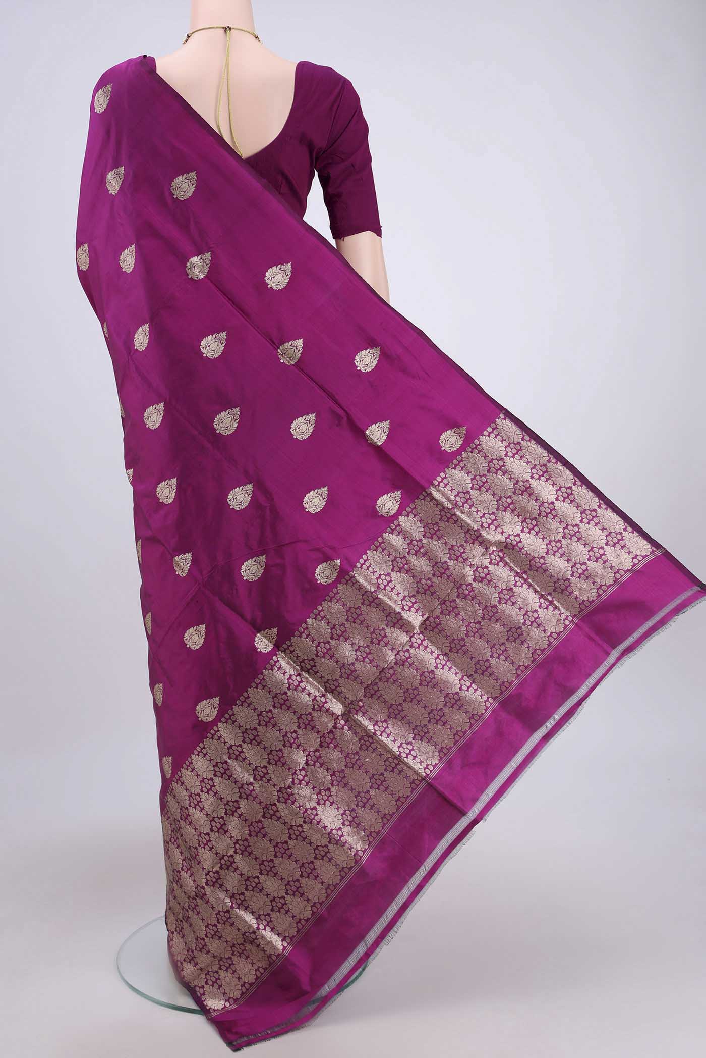 Flat view of Magenta Banarasi Katan Silk Saree with Zari Butta on the body and Without Border. 