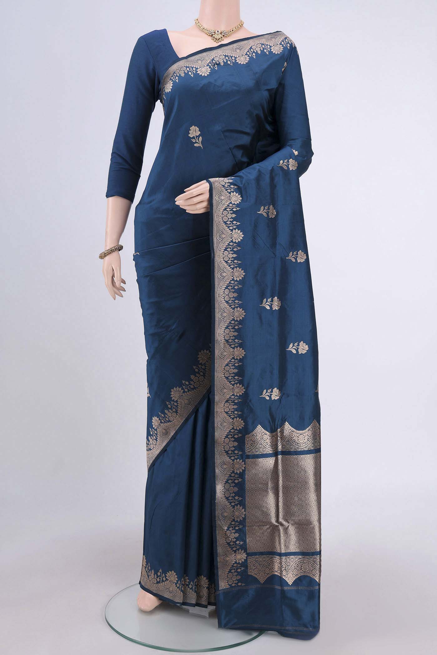 Blue Banarasi Katan Silk Saree with Zari Butta on the body and Zari Border.  displayed on a mannequin