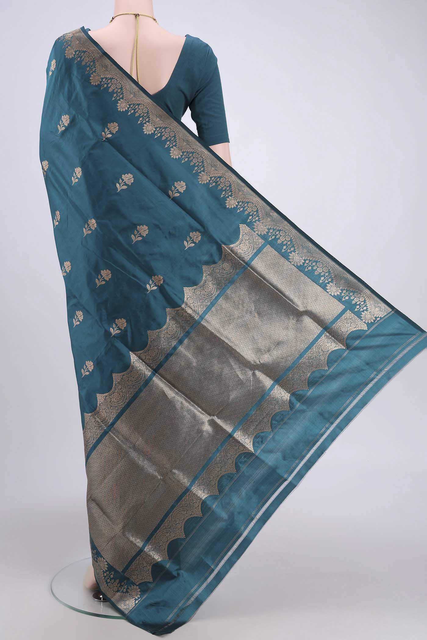 Flat view of Sea Green Banarasi Katan Silk Saree with Zari Butta on the body and Zari Border. 