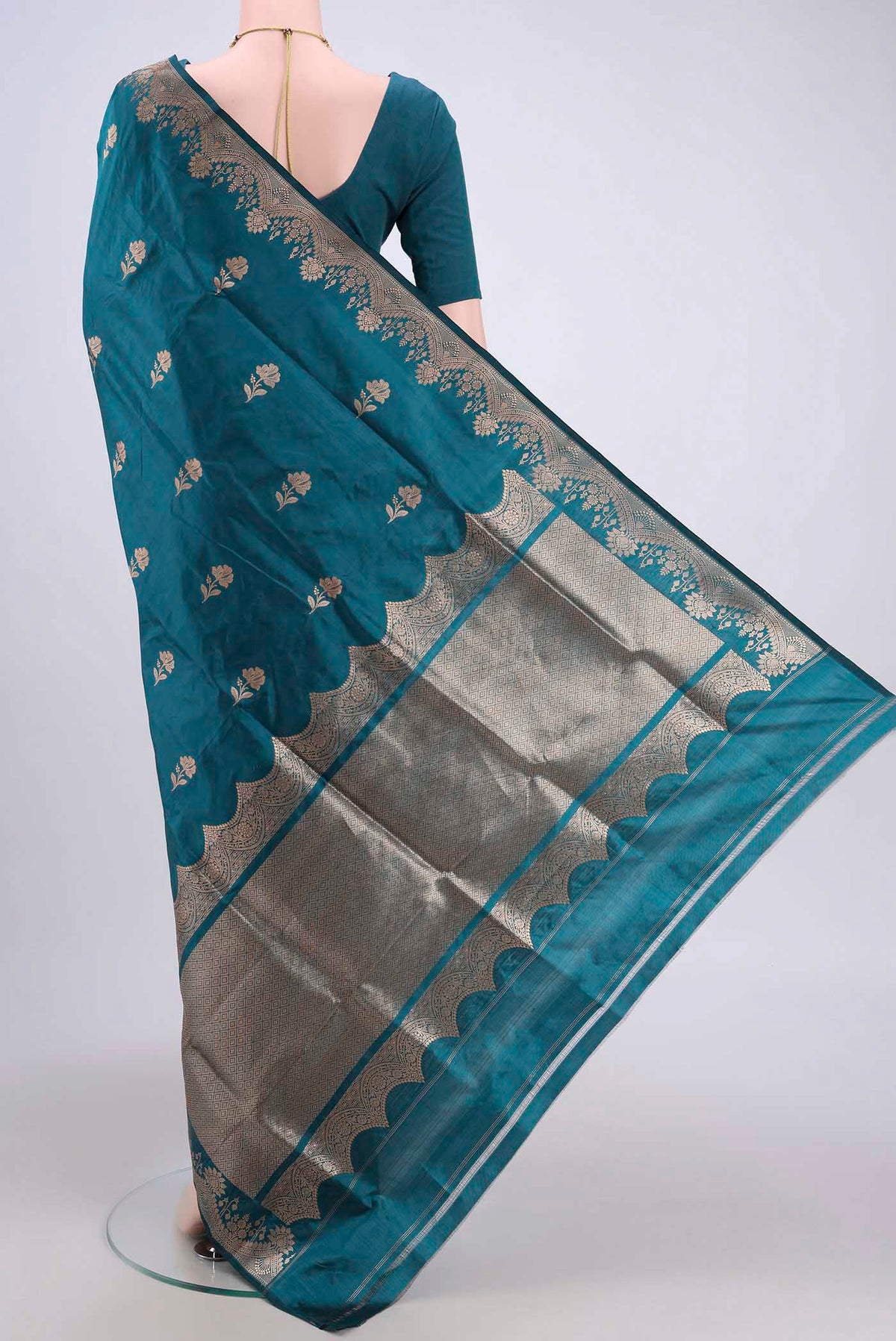 Flat view of Sea Green Banarasi Katan Silk Saree with Zari Butta on the body and Zari Border. 