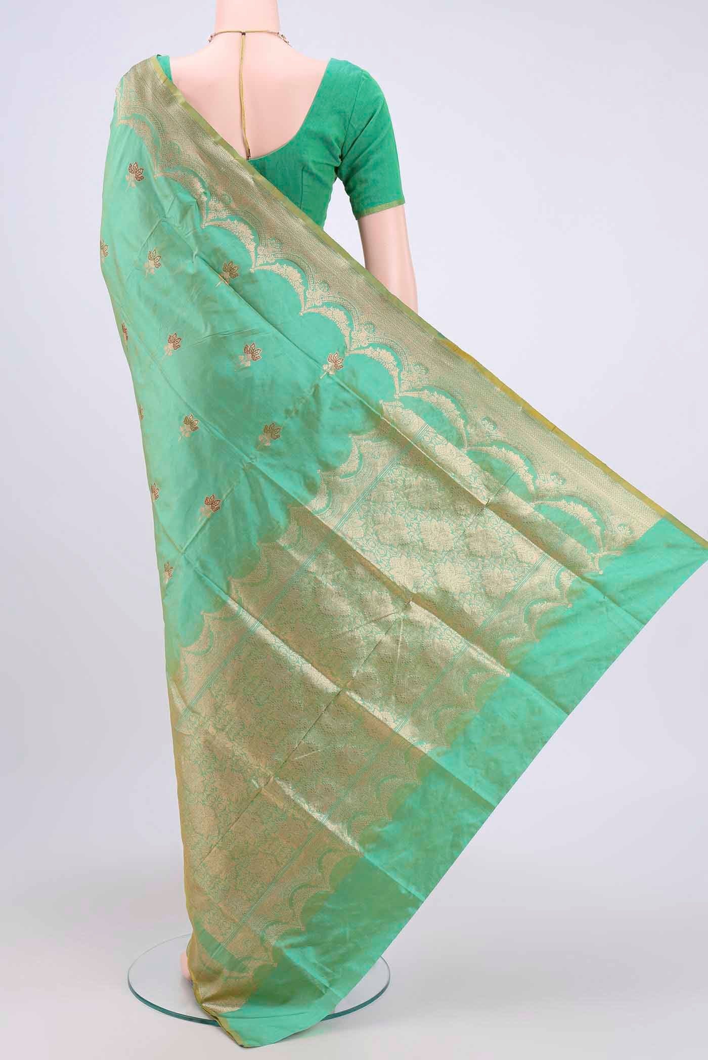 Flat view of Acid Green Dual Tone Banarasi Katan Silk Saree with Zari Butta on the body and Zari Border. 