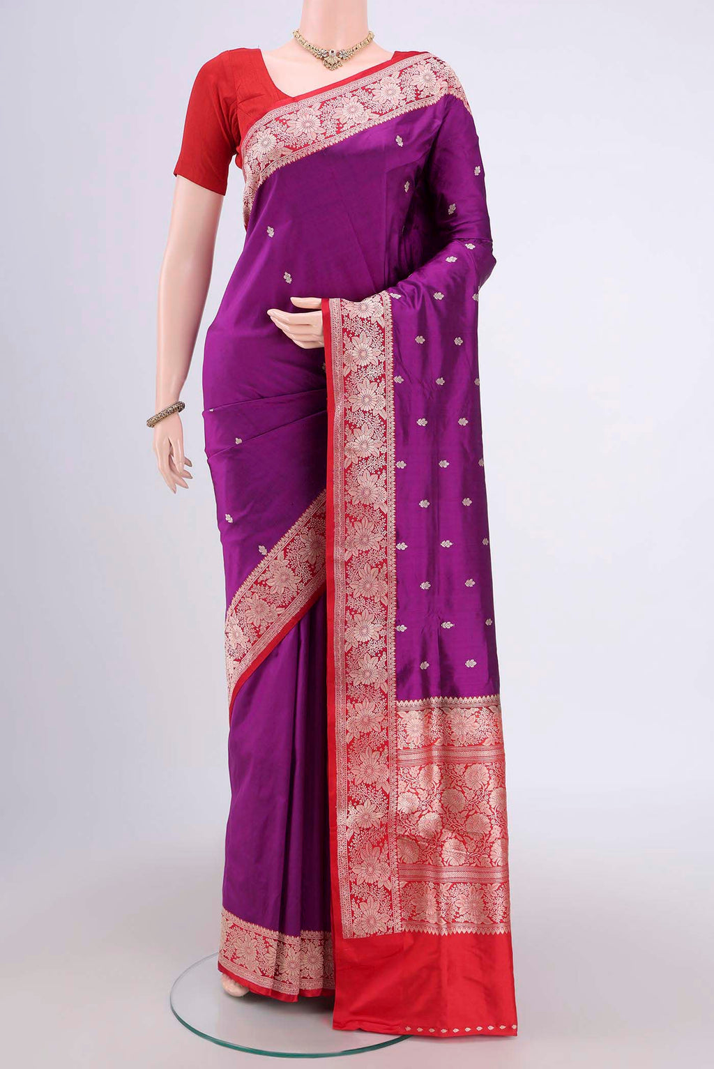 Magenta Banarasi Katan Silk Saree with Zari Butta on the body and Zari Border.  displayed on a mannequin