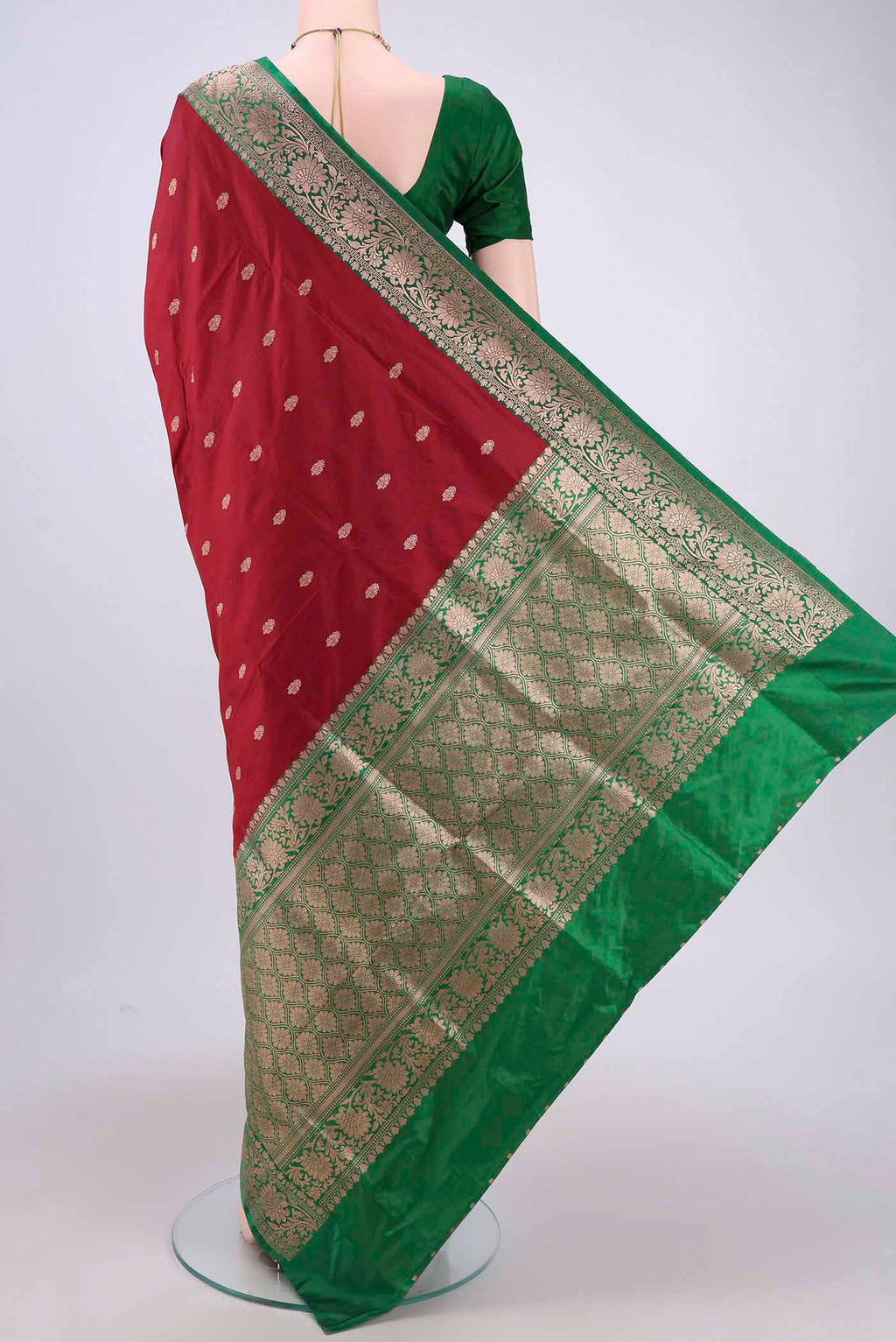 Flat view of Maroon Banarasi Katan Silk Saree with Zari Butta on the body and Zari Border. 