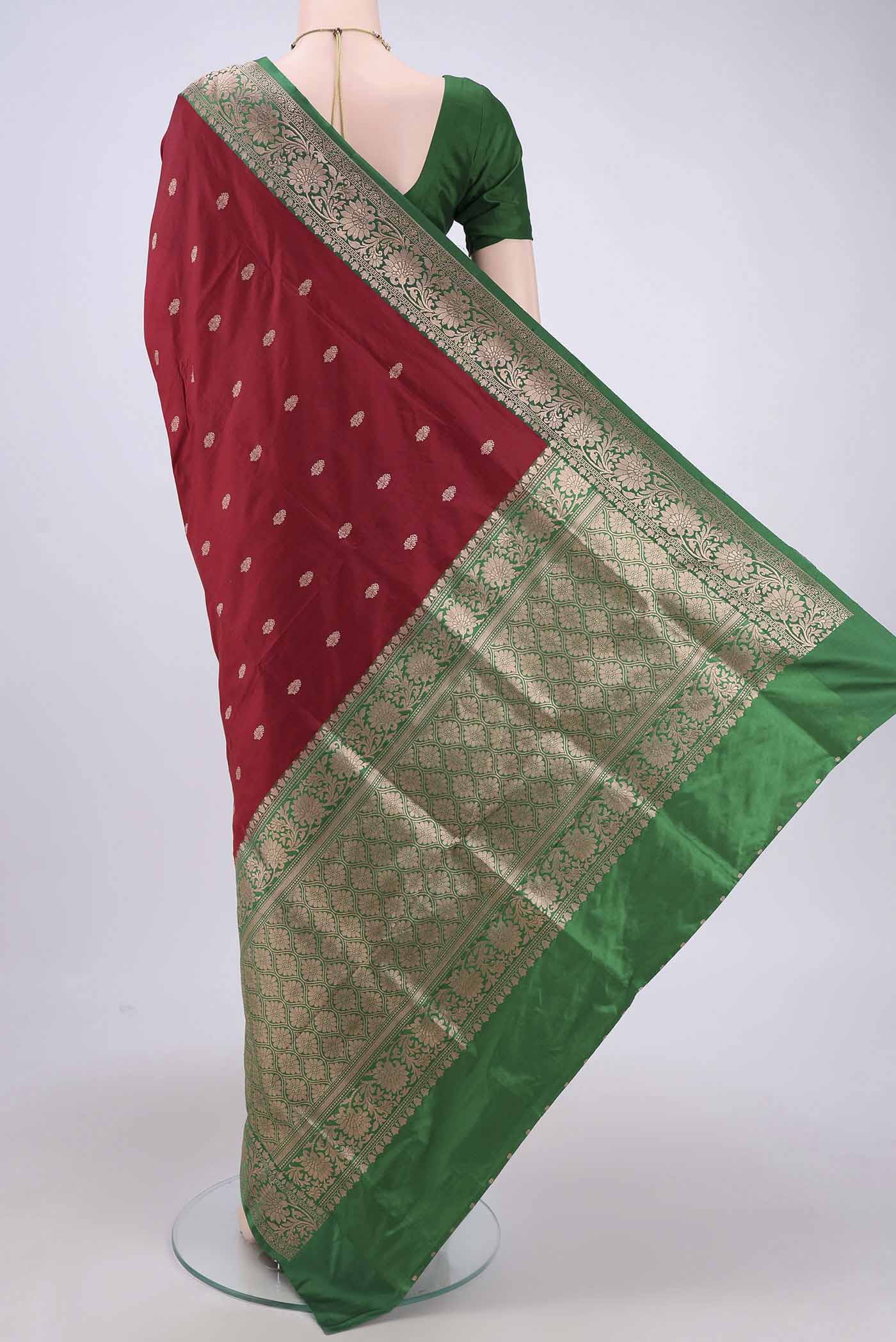 Flat view of Maroon Banarasi Katan Silk Saree with Zari Butta on the body and Zari Border. 