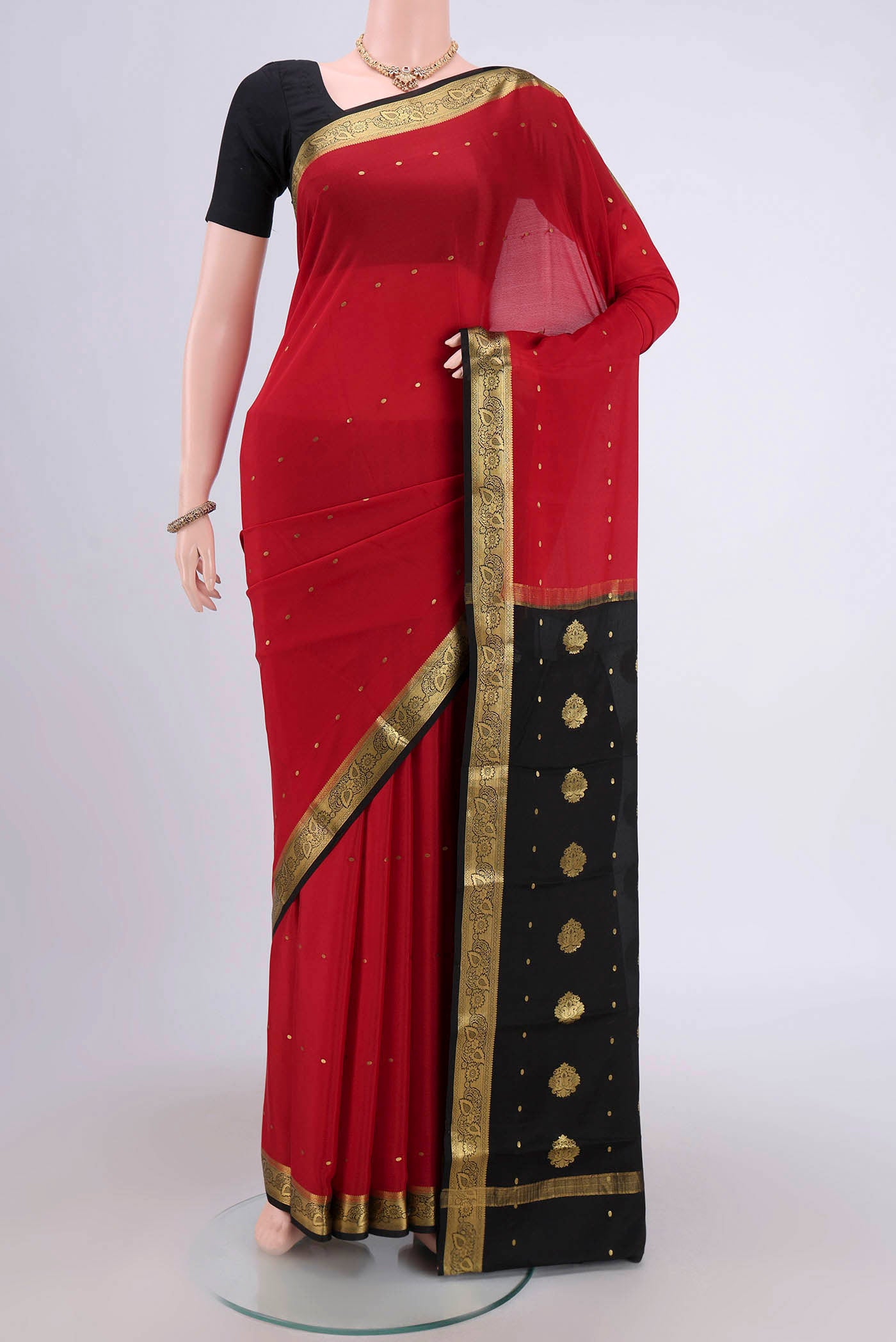 Red Mysore Crepe Saree with Zari Butta on the body and Zari Border.  displayed on a mannequin