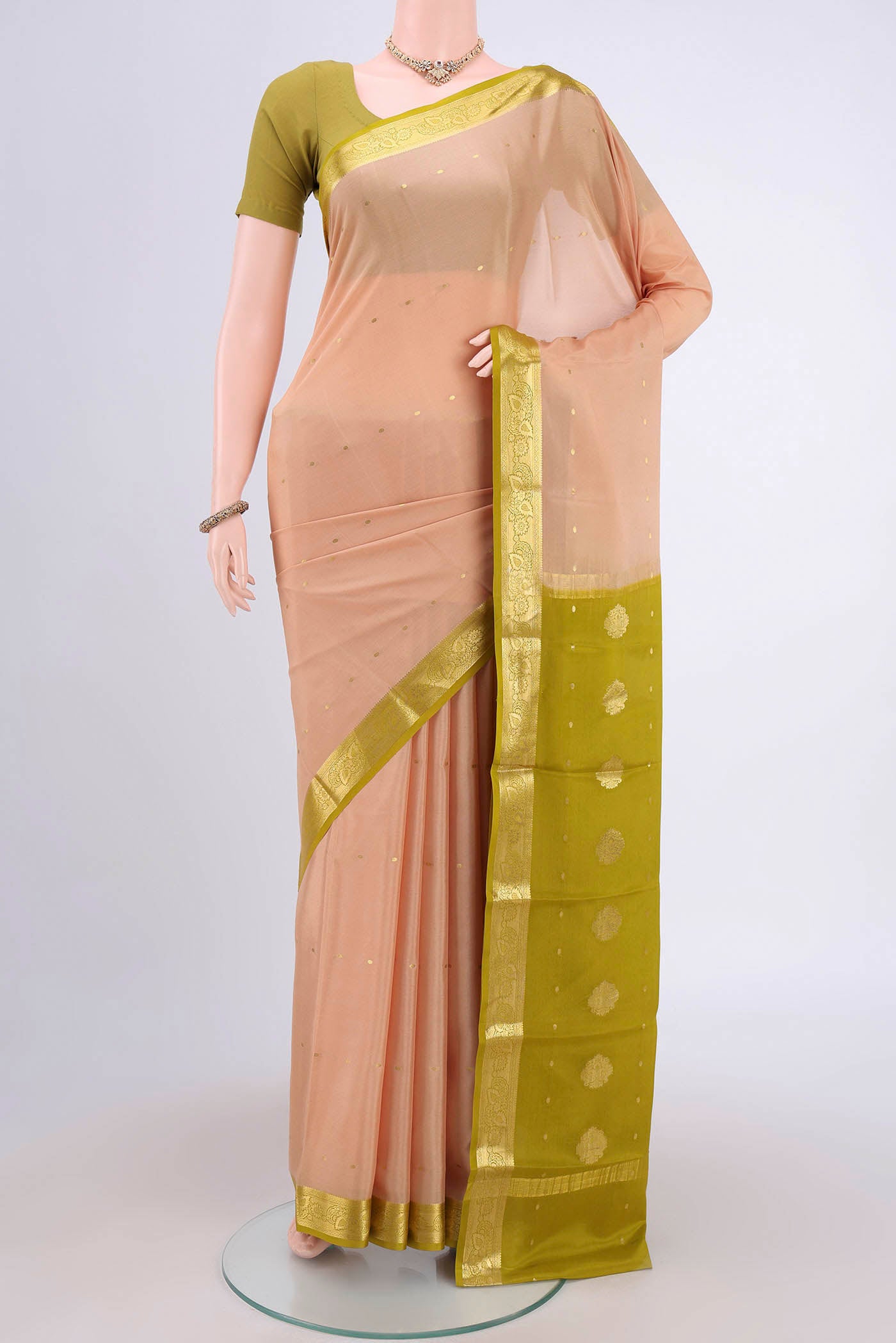 Sandal Mysore Crepe Saree with Zari Butta on the body and Zari Border.  displayed on a mannequin