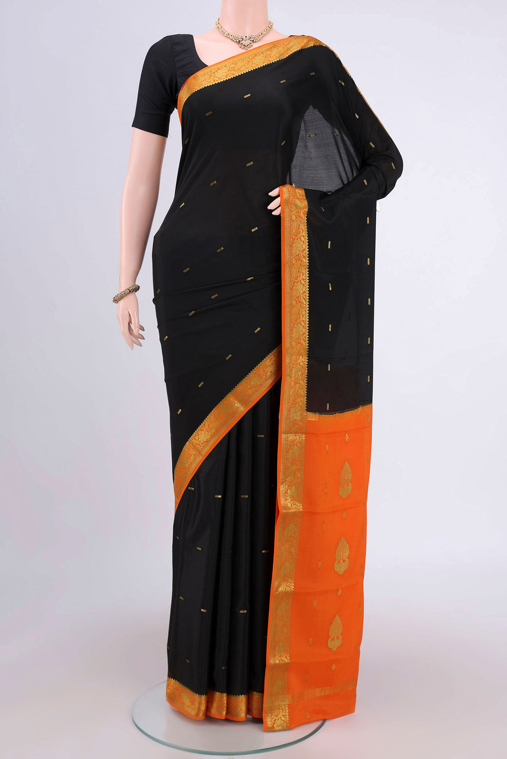 Black Mysore Crepe Saree with Zari Butta on the body and Zari Border.  displayed on a mannequin