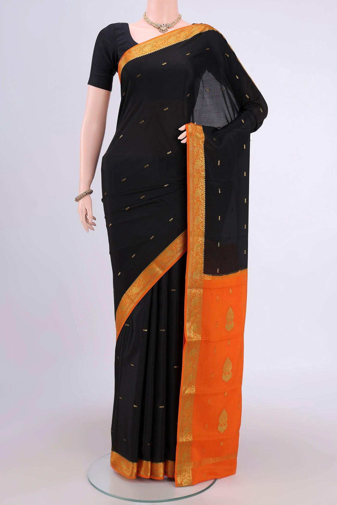 Black Mysore Crepe Saree with Zari Butta on the body and Zari Border.  displayed on a mannequin