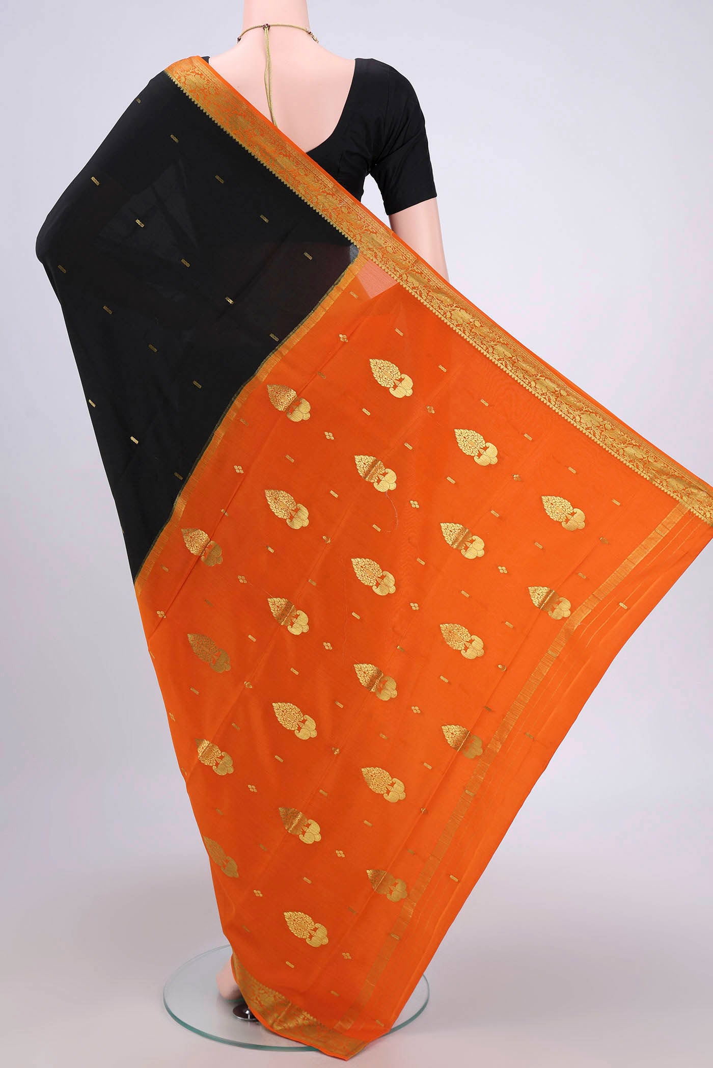 Flat view of Black Mysore Crepe Saree with Zari Butta on the body and Zari Border. 