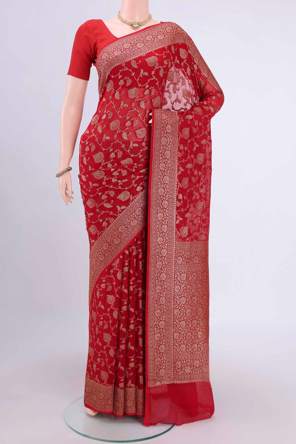 Red Banarasi Georgette Saree with Zari Brocade on the body and Zari Border.  displayed on a mannequin