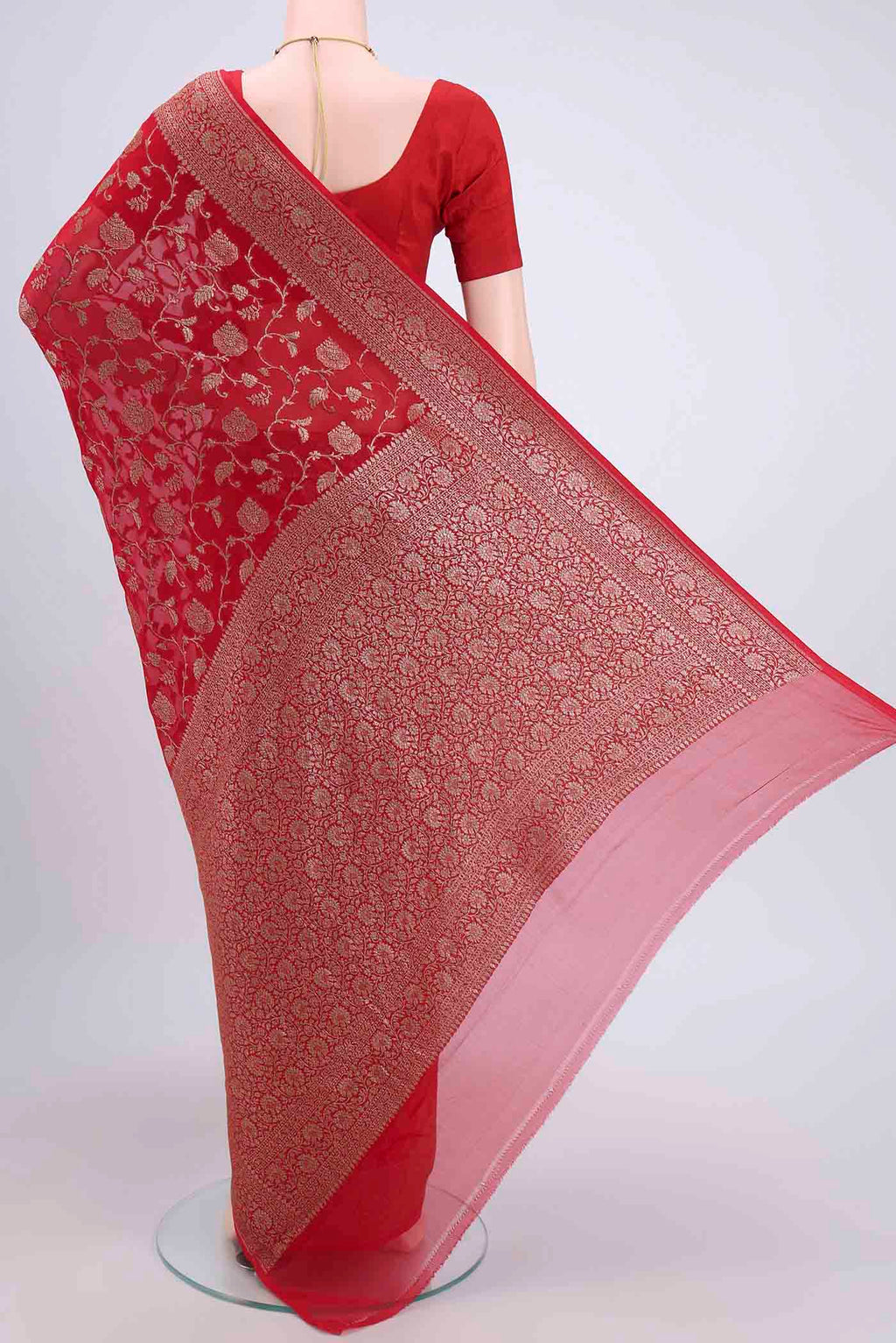 Flat view of Red Banarasi Georgette Saree with Zari Brocade on the body and Zari Border. 