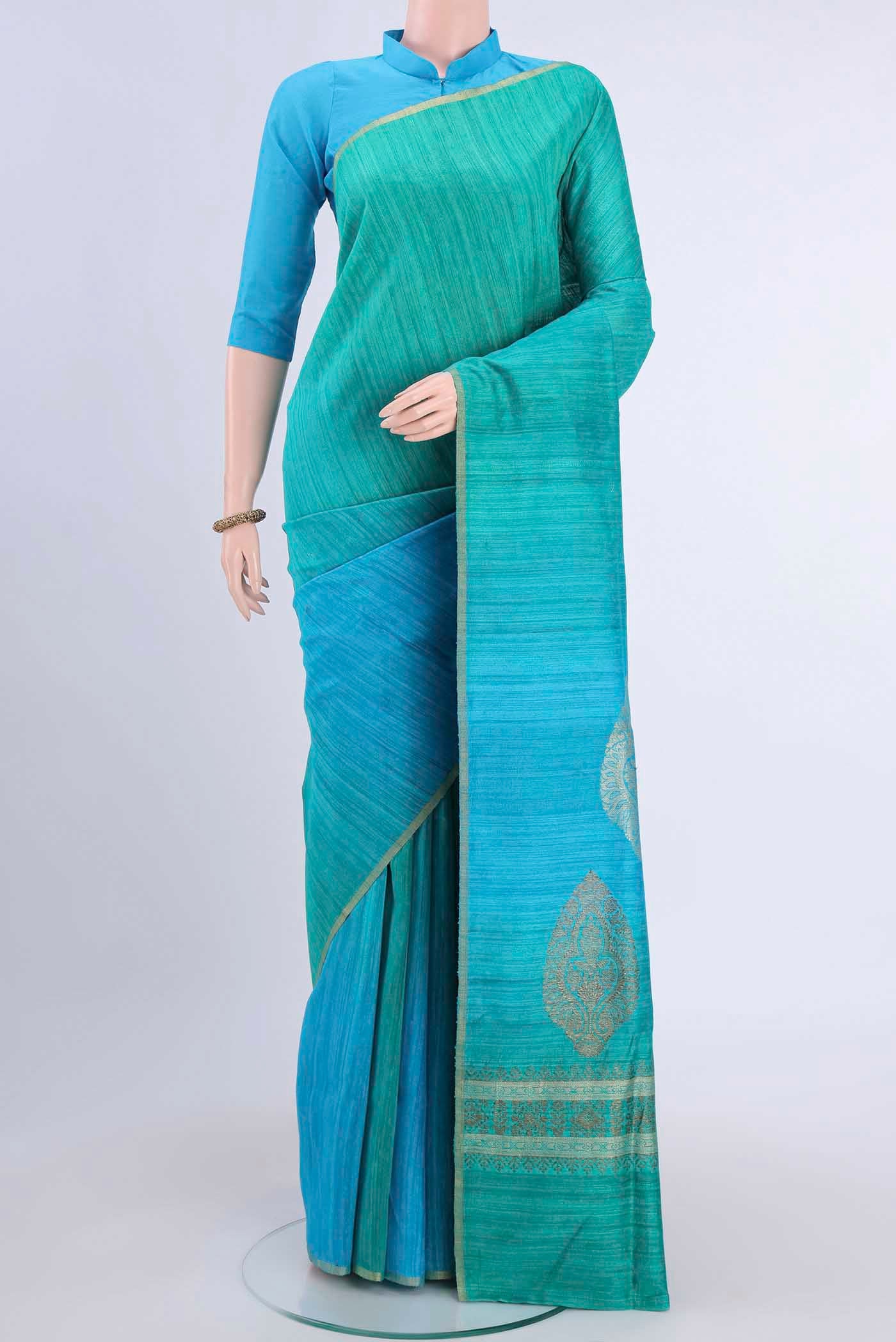 Turquoise and Green Color Banarasi Tussar Silk Saree with Ombre design on the body and Thin Zari Line displayed on a mannequin