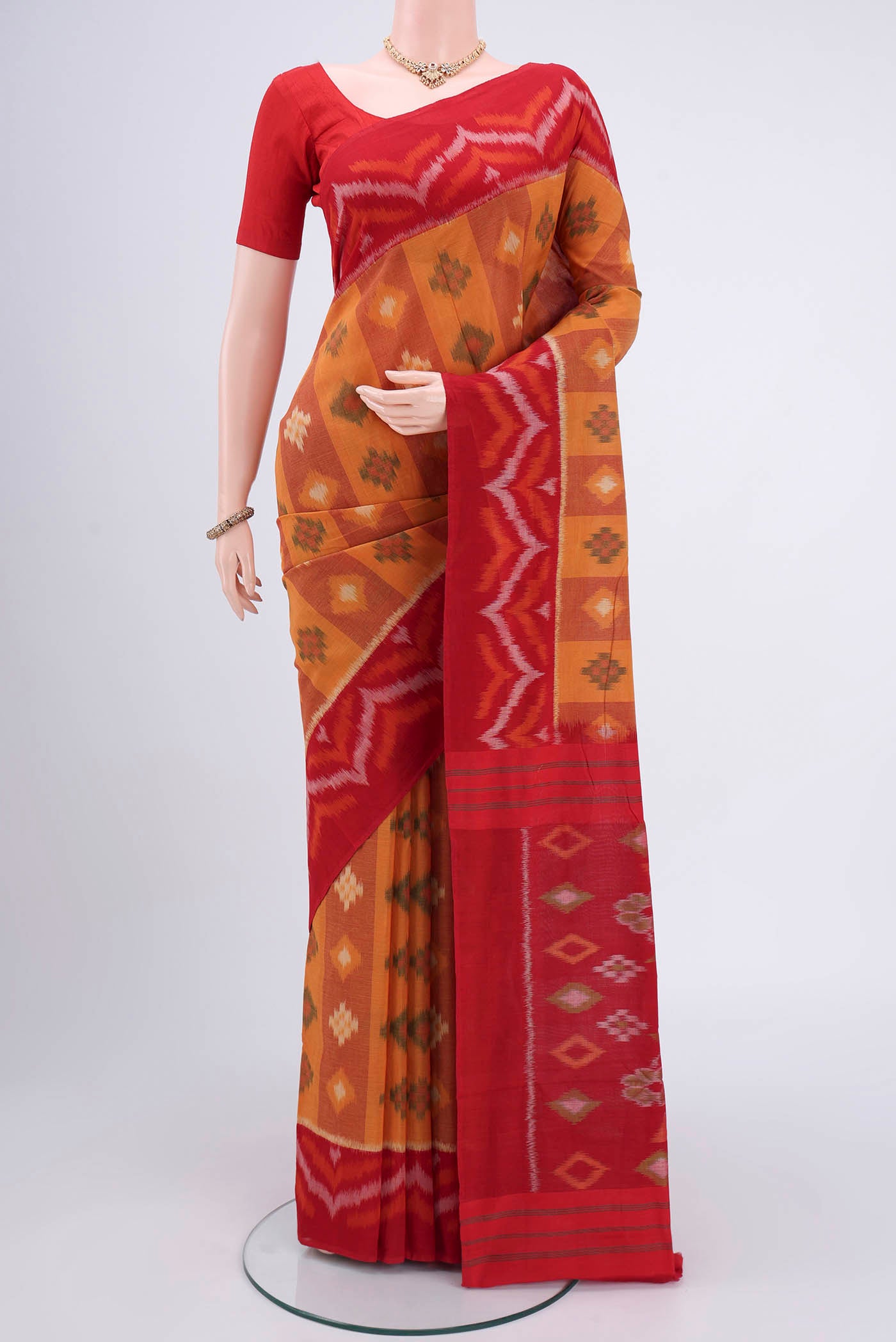 Mustard Pochampally Cotton Saree with Ikat design on the body and Ikat Border.  displayed on a mannequin