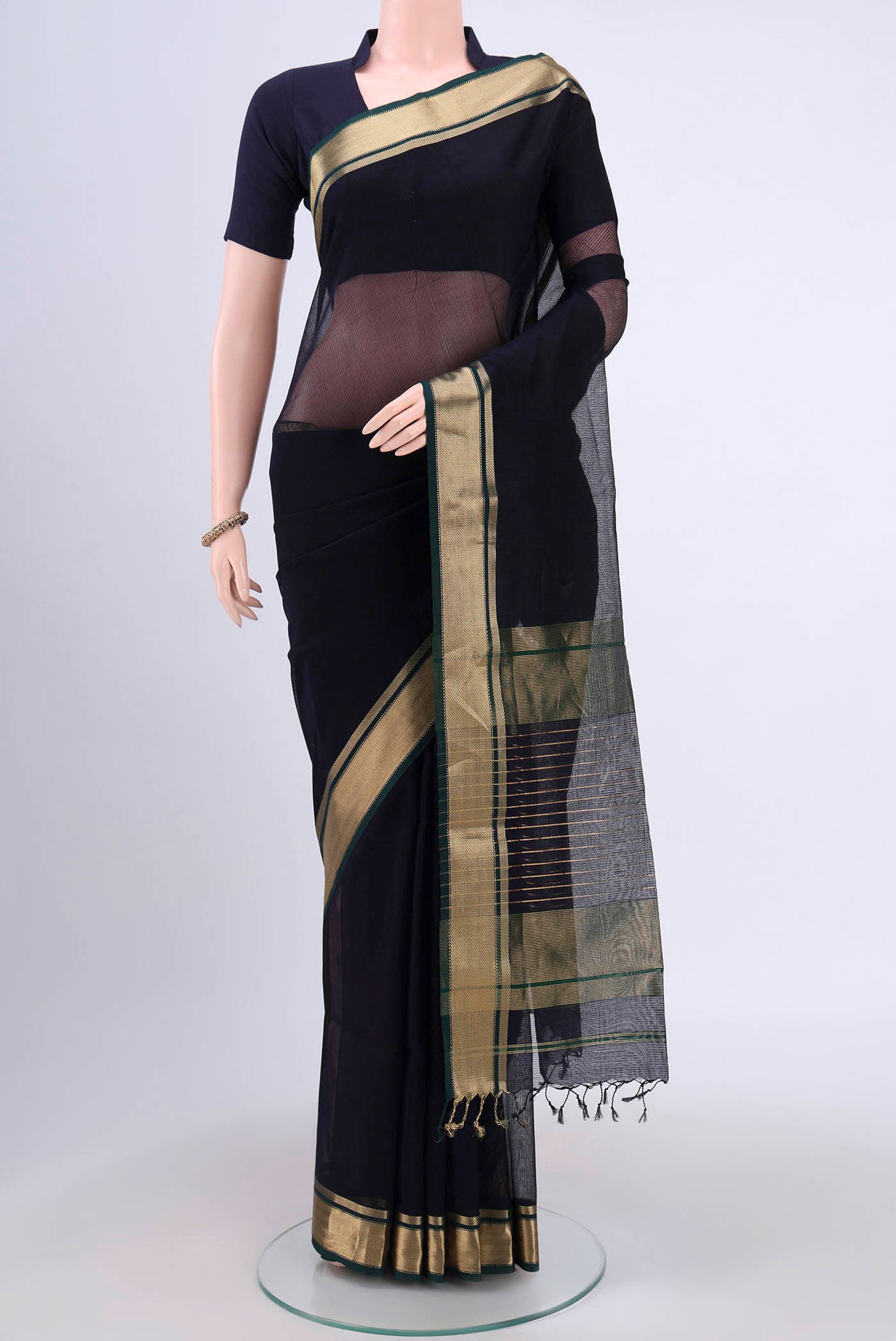 Navy Blue Maheshwari Silk Cotton Saree with Plain Body and Zari Border.  displayed on a mannequin