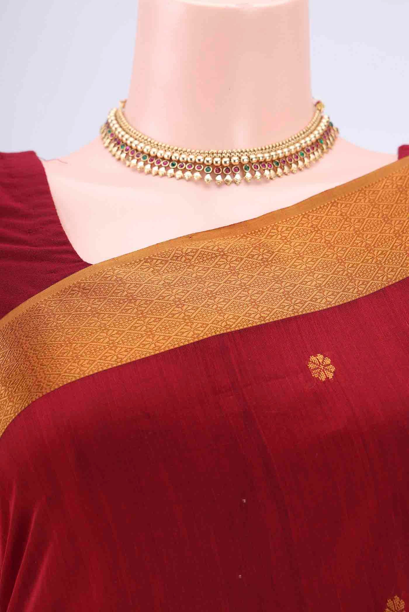 Border image of Maroon Dual Tone Maheshwari Silk Cotton Saree with Zari And Thread Butta on the body and Zari Border. 