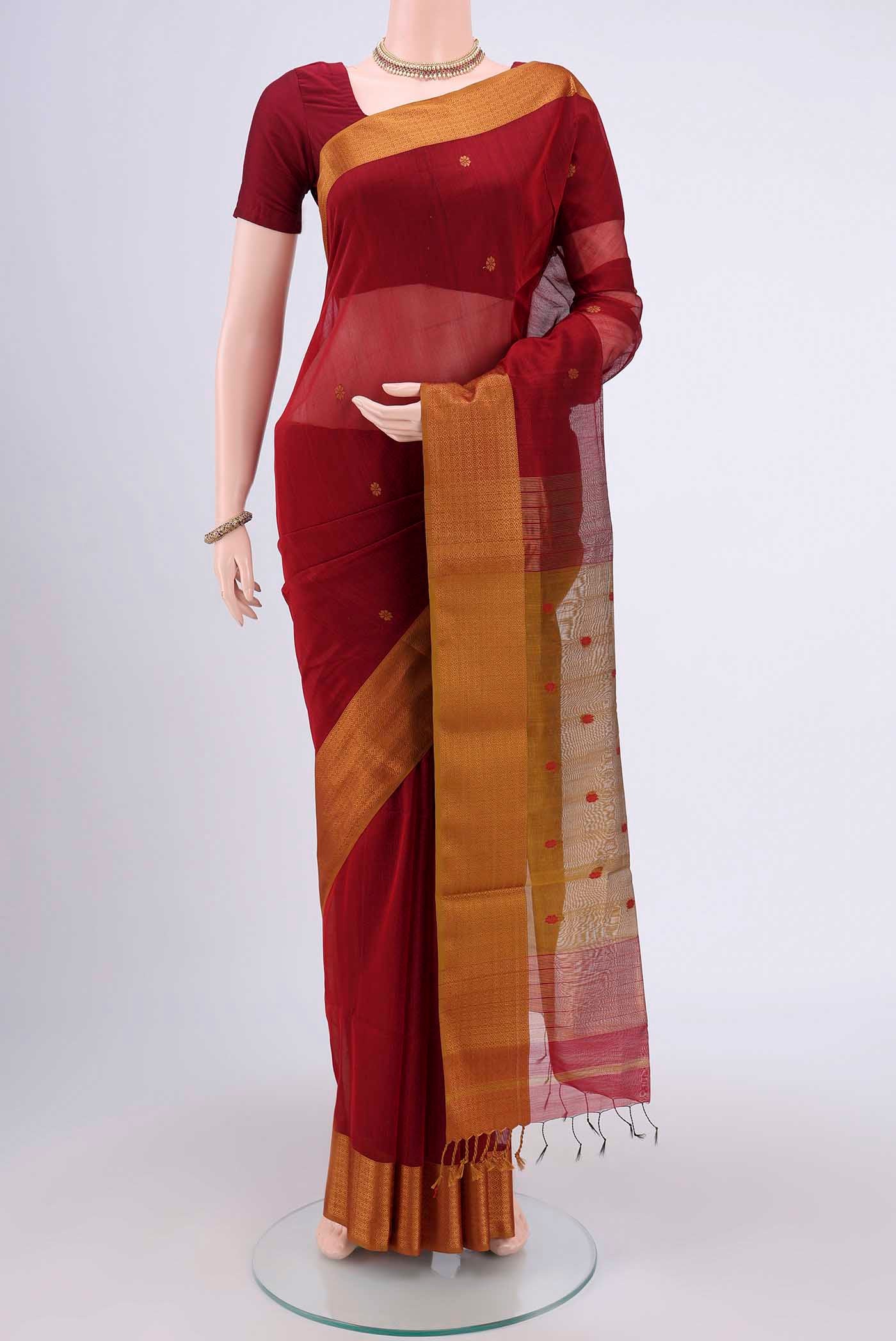 Maroon Dual Tone Maheshwari Silk Cotton Saree with Zari And Thread Butta on the body and Zari Border.  displayed on a mannequin