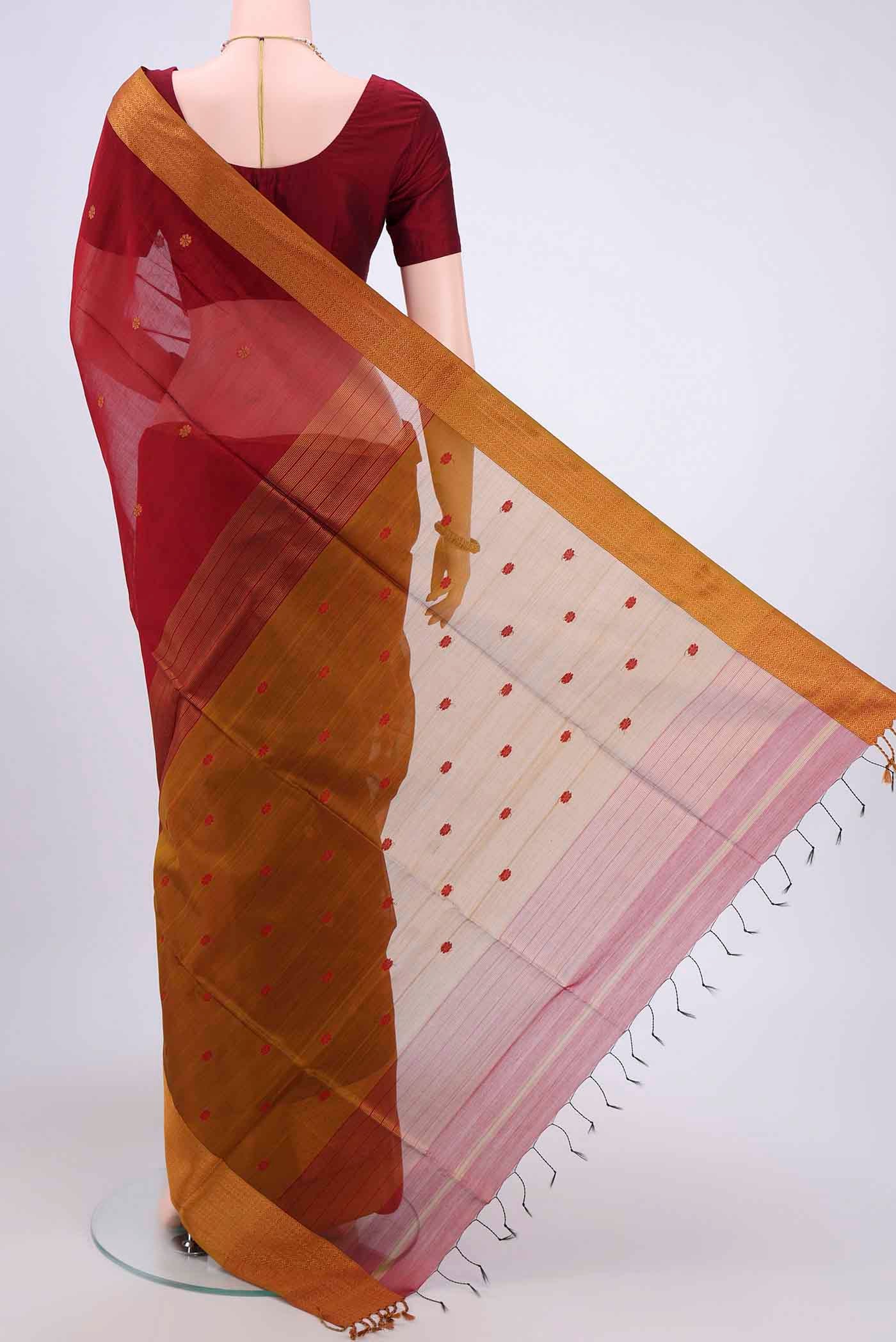 Flat view of Maroon Dual Tone Maheshwari Silk Cotton Saree with Zari And Thread Butta on the body and Zari Border. 