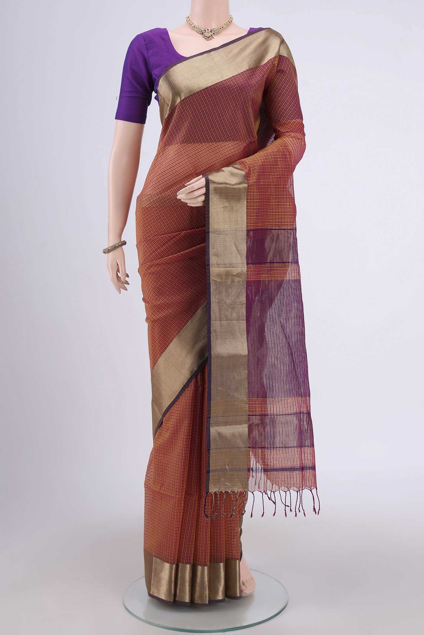 Mustard Maheshwari Silk Cotton Saree with Stripes on the body and Zari Border.  displayed on a mannequin